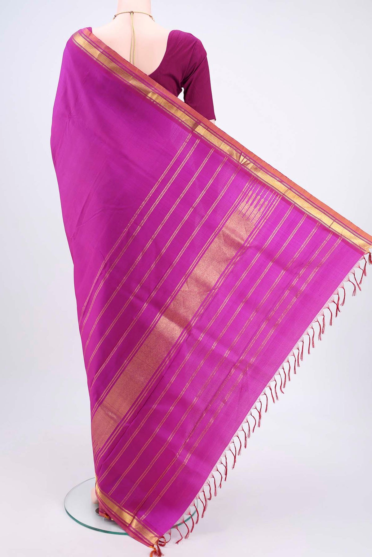 Flat view of Magenta Kanjivaram Silk Saree with Plain Body and Zari Border. 