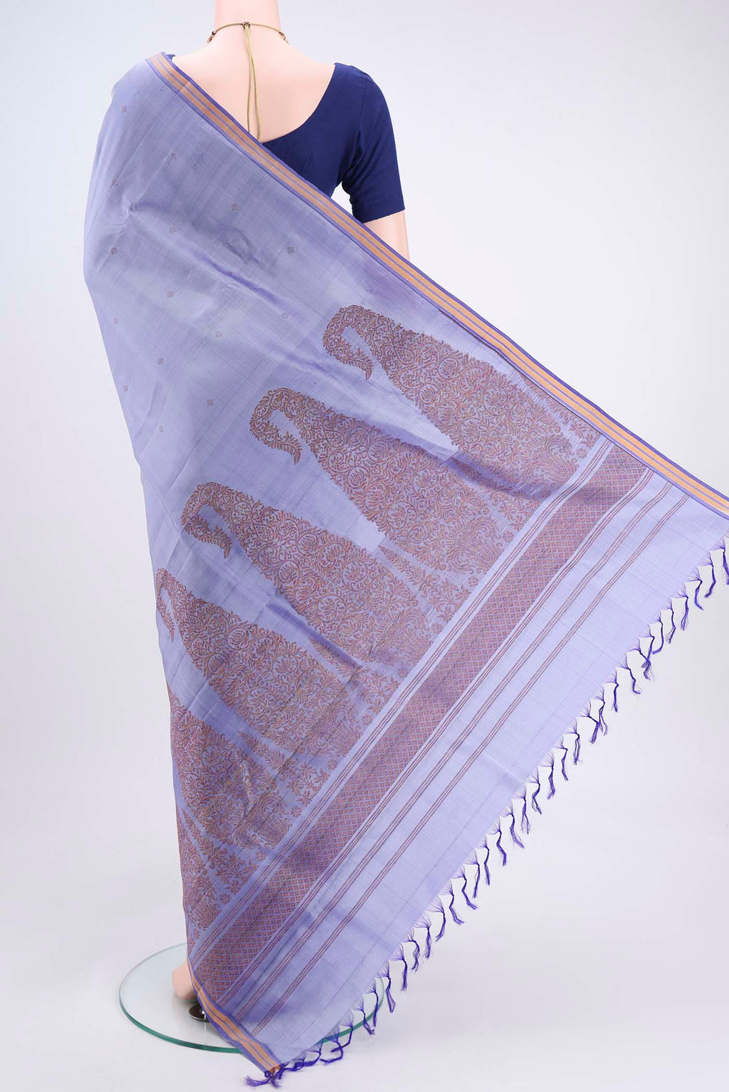 Flat view of Violet Kanchipuram Silk Saree with Zari Butta on the body and Plain Border. 