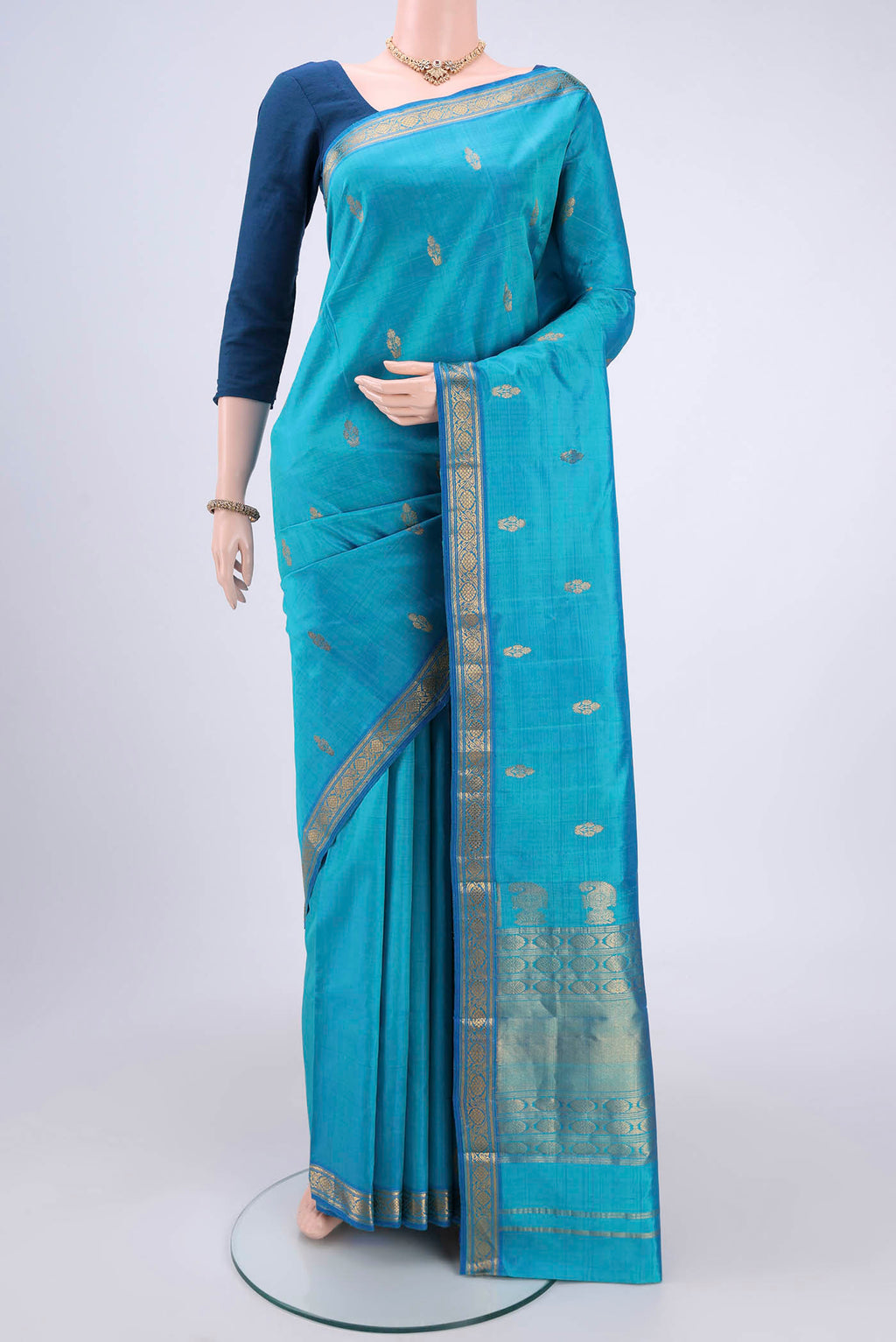 Blue Kanjivaram Silk Saree with Zari Butta on the body and Zari Border.  displayed on a mannequin