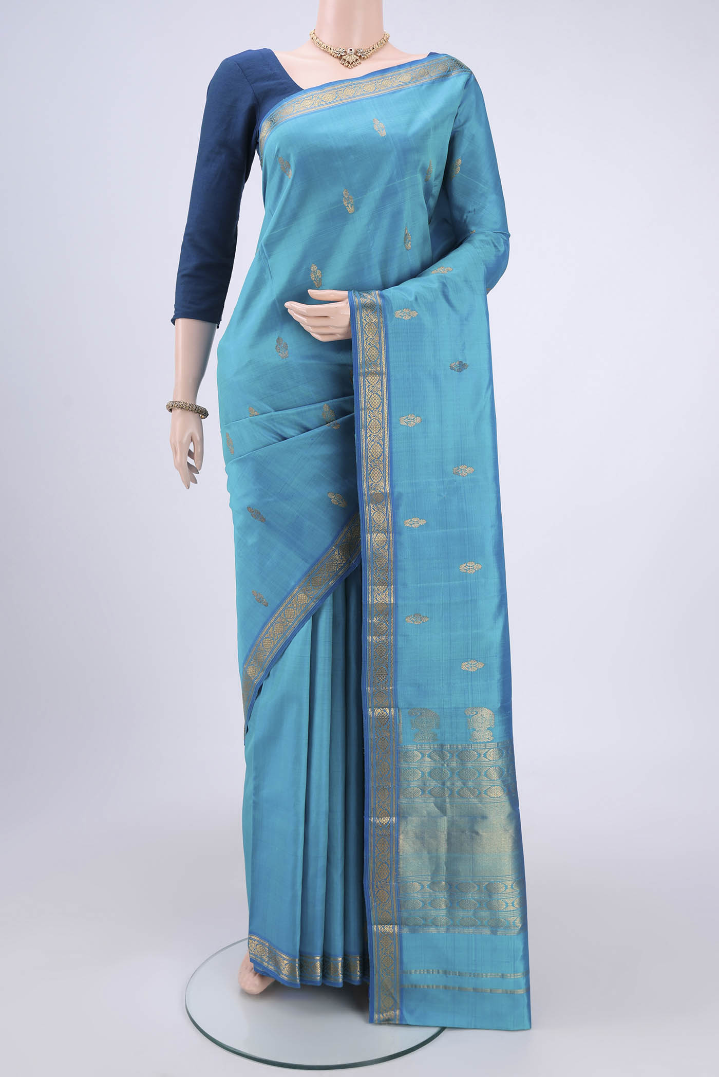Blue Kanjivaram Silk Saree with Zari Butta on the body and Zari Border.  displayed on a mannequin