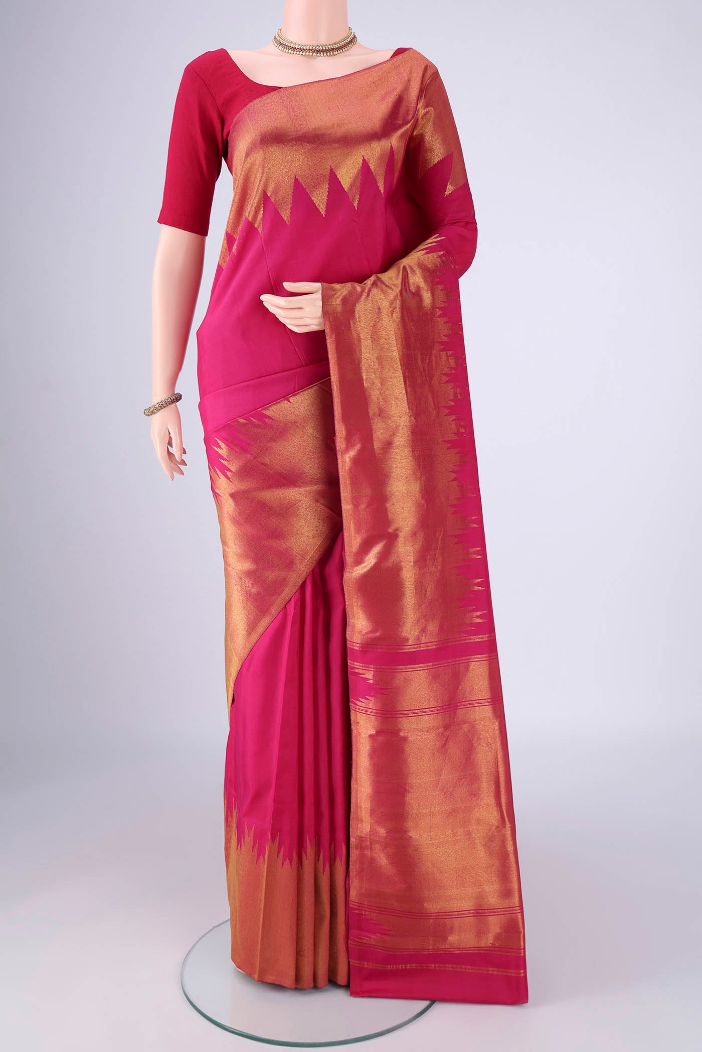 Pink Kanjivaram Silk Saree with Plain Body and Temple Border.  displayed on a mannequin