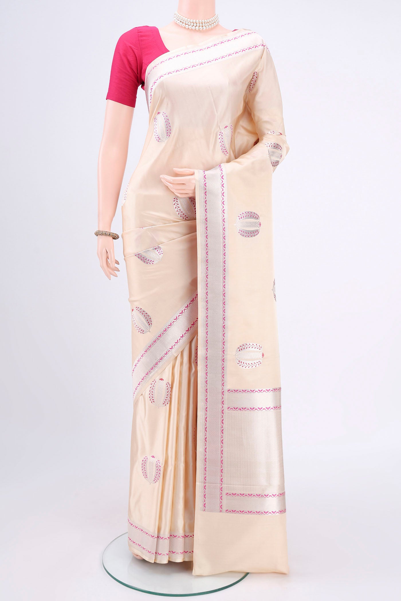 Cream Banarasi Silk Saree with Zari And Thread Butta on the body and Zari And Thread Border.  displayed on a mannequin