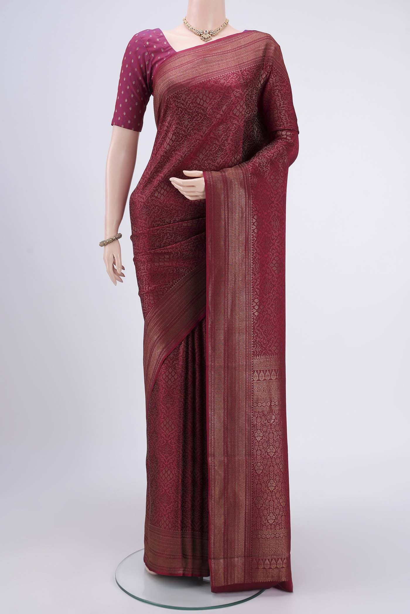 Maroon Mysore Crepe Saree with Zari Brocade on the body and Zari Border.  displayed on a mannequin