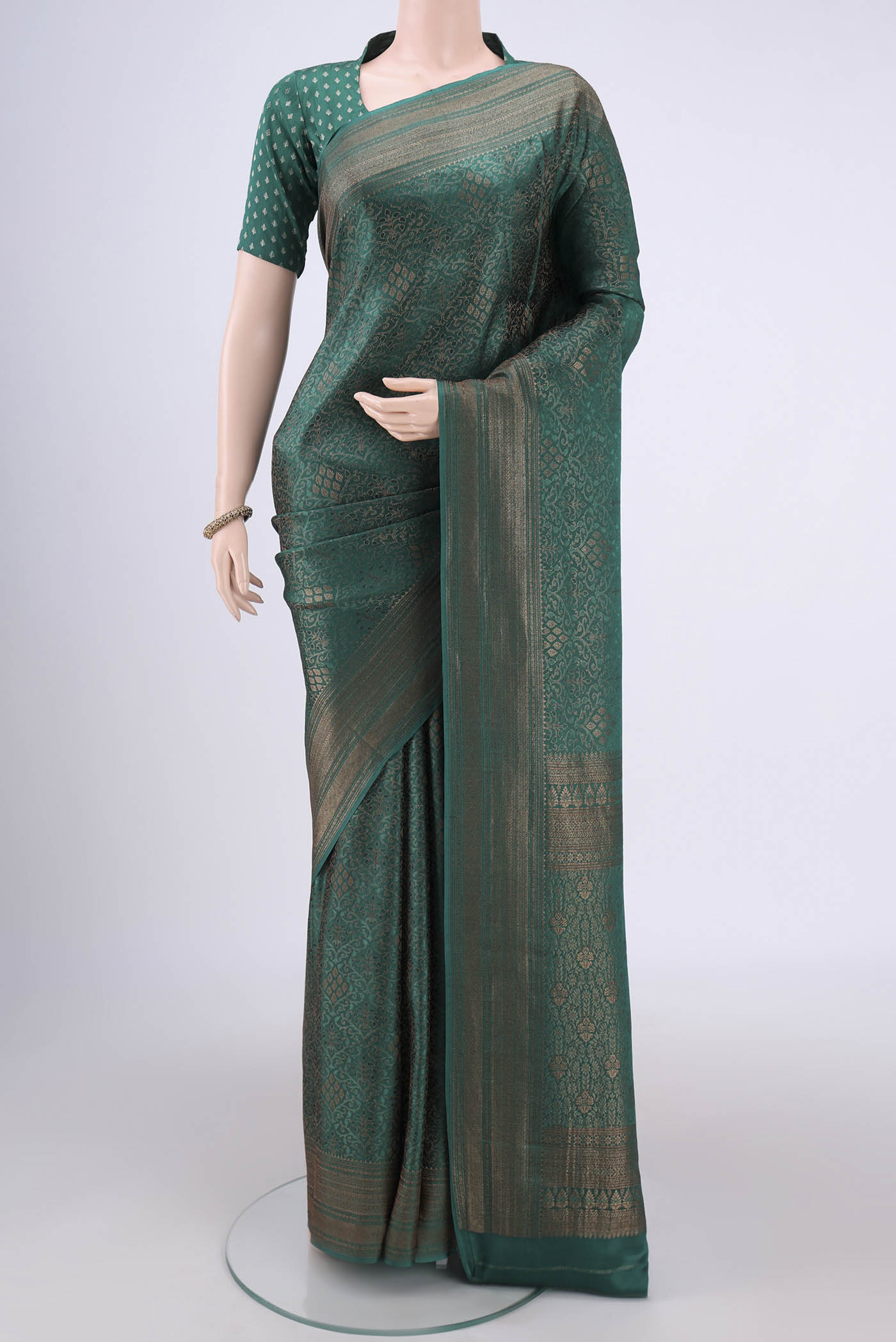 Green Mysore Crepe Saree with Zari Brocade on the body and Zari Border.  displayed on a mannequin