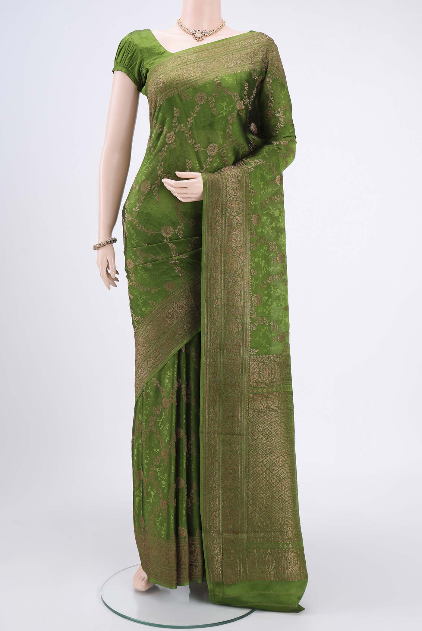 Green Mysore Crepe Saree with Zari Brocade on the body and Zari Border.  displayed on a mannequin