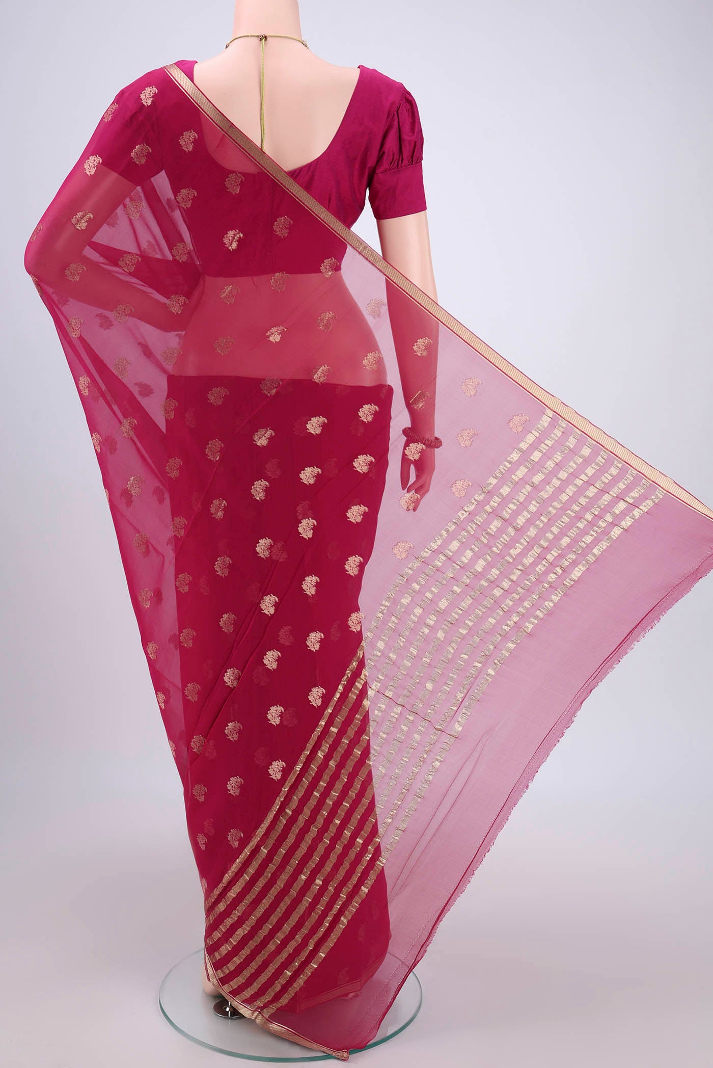 Flat view of Rani Pink Mysore Chiffon Saree with Zari Butta on the body and Zari Border. 