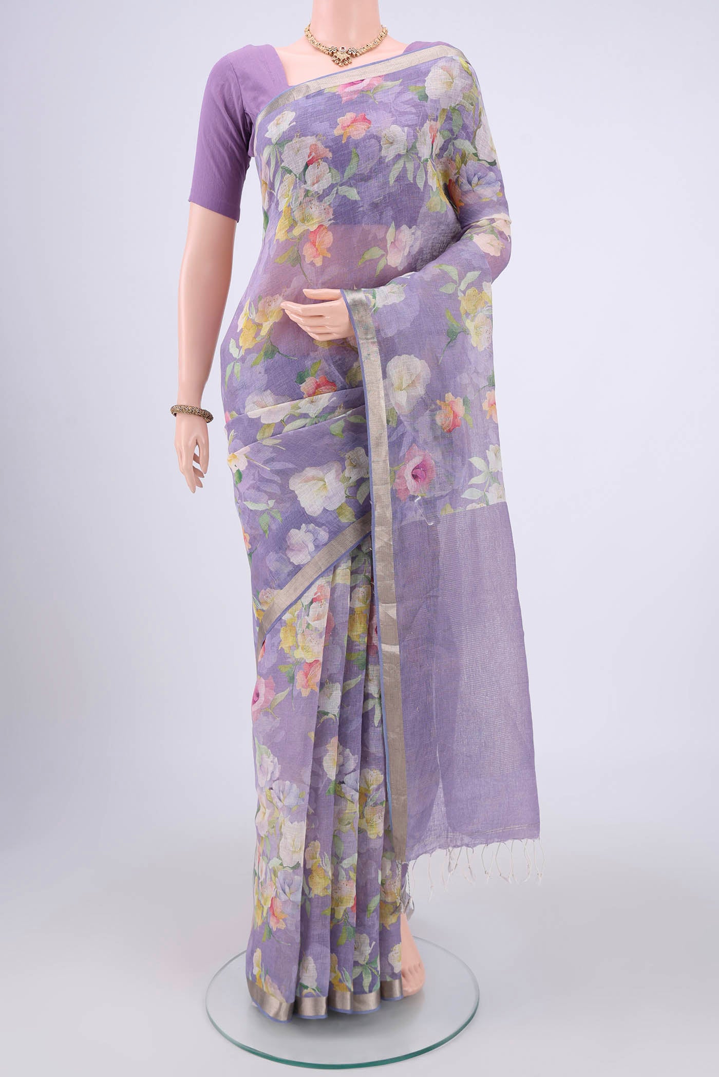 Purple Linen Saree with Floral Print on the body and Zari Border.  displayed on a mannequin