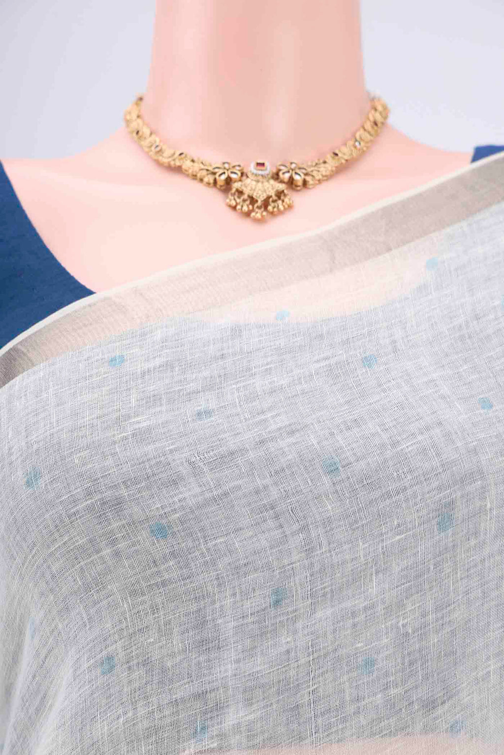 Border image of White Linen Saree with Floral Print on the body and Zari Border. 