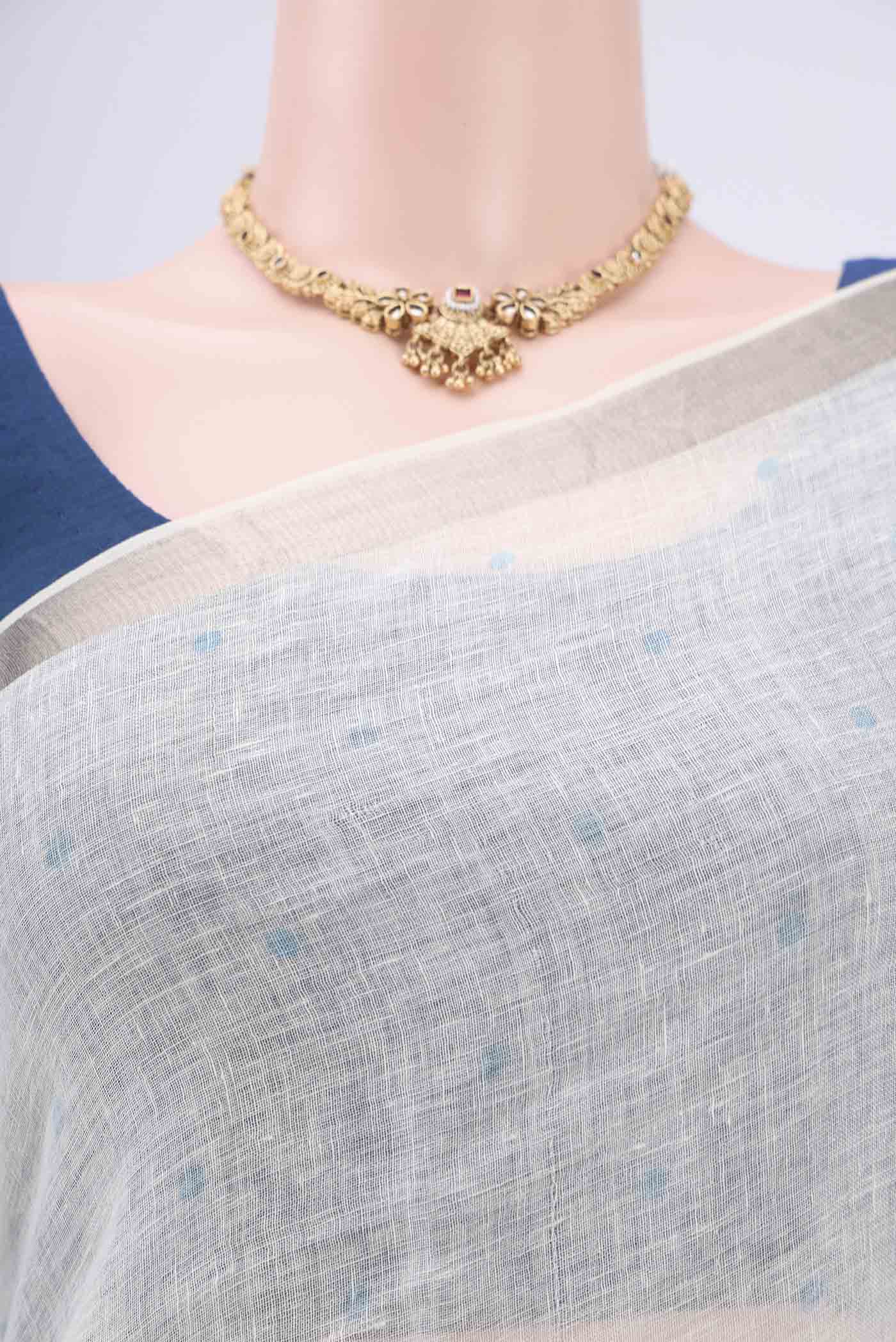 Border image of White Linen Saree with Floral Print on the body and Zari Border. 