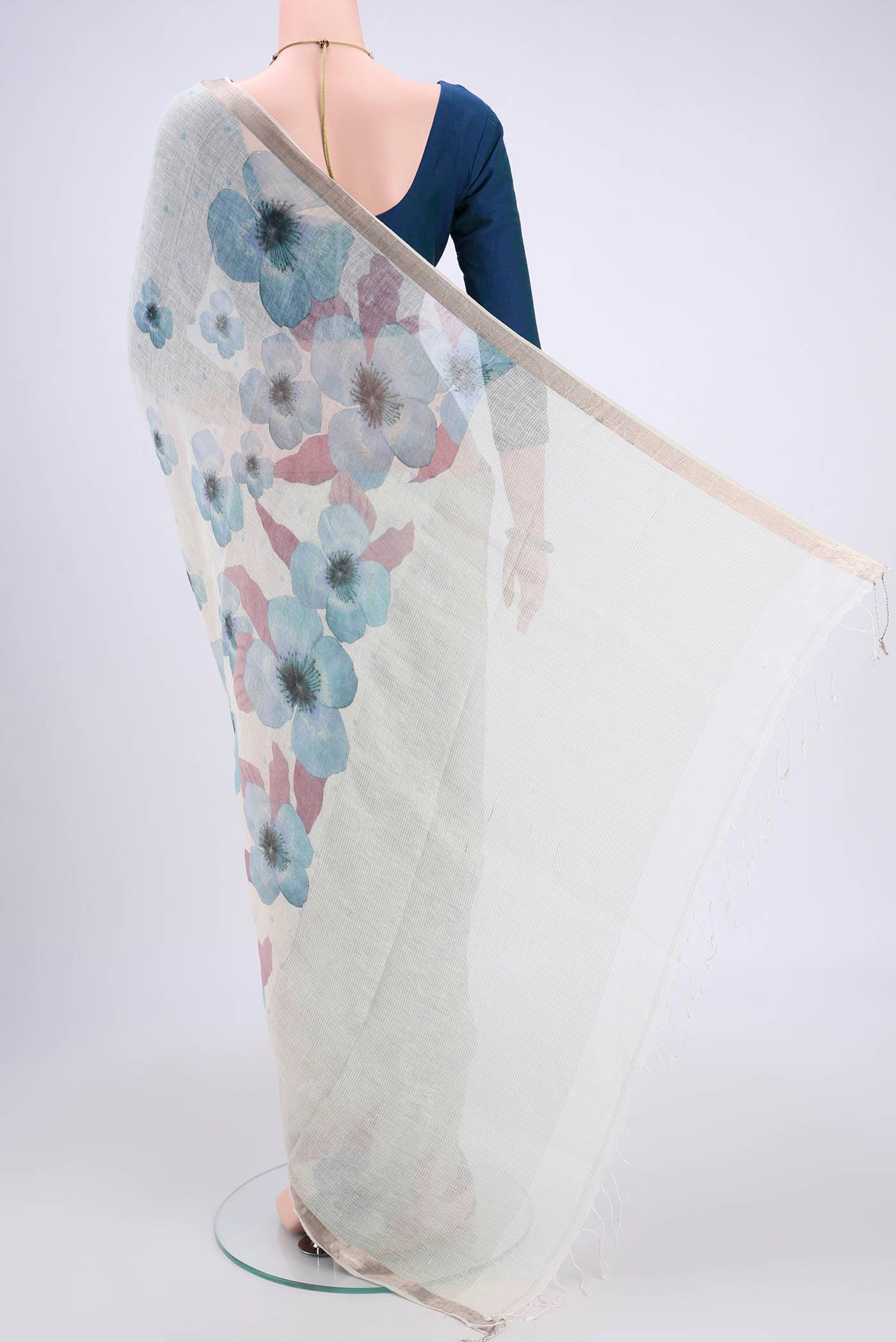 Flat view of White Linen Saree with Floral Print on the body and Zari Border. 