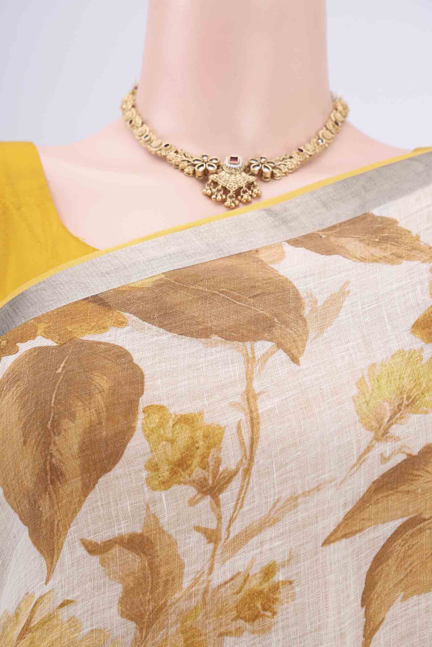Border image of Beige Linen Saree with Floral Print on the body and Zari Border. 