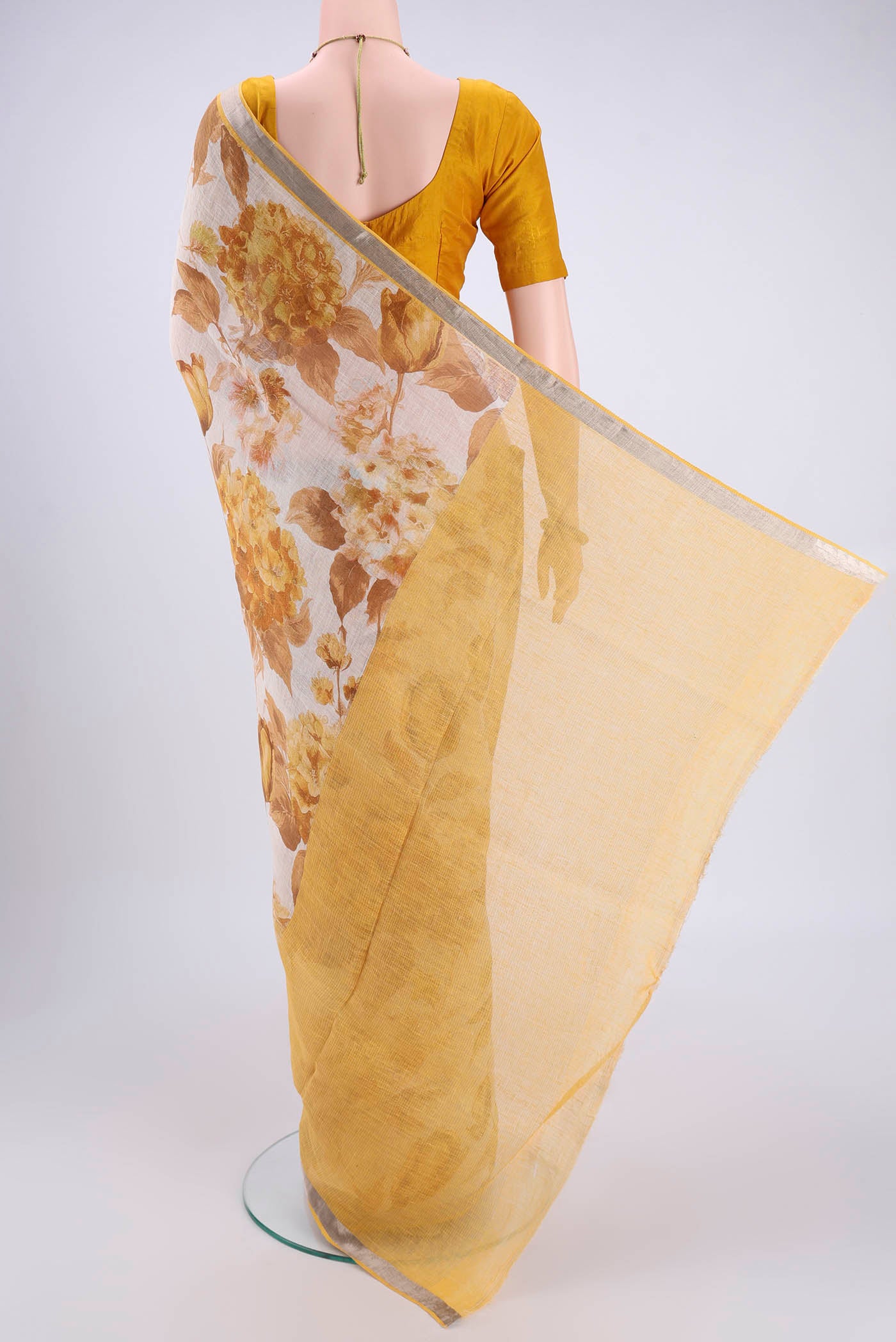 Flat view of Beige Linen Saree with Floral Print on the body and Zari Border. 