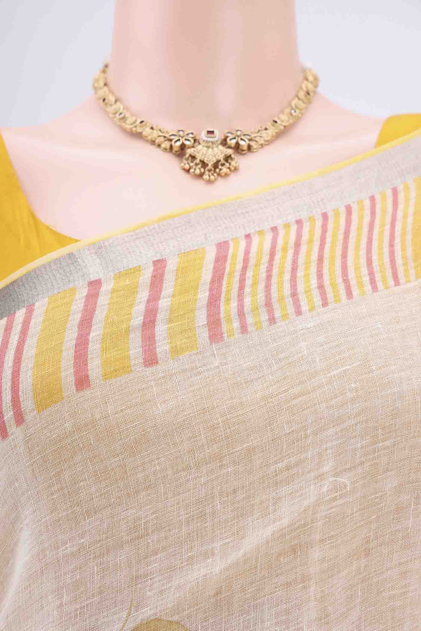 Border image of Beige Linen Saree with Floral Print on the body and Zari Border. 
