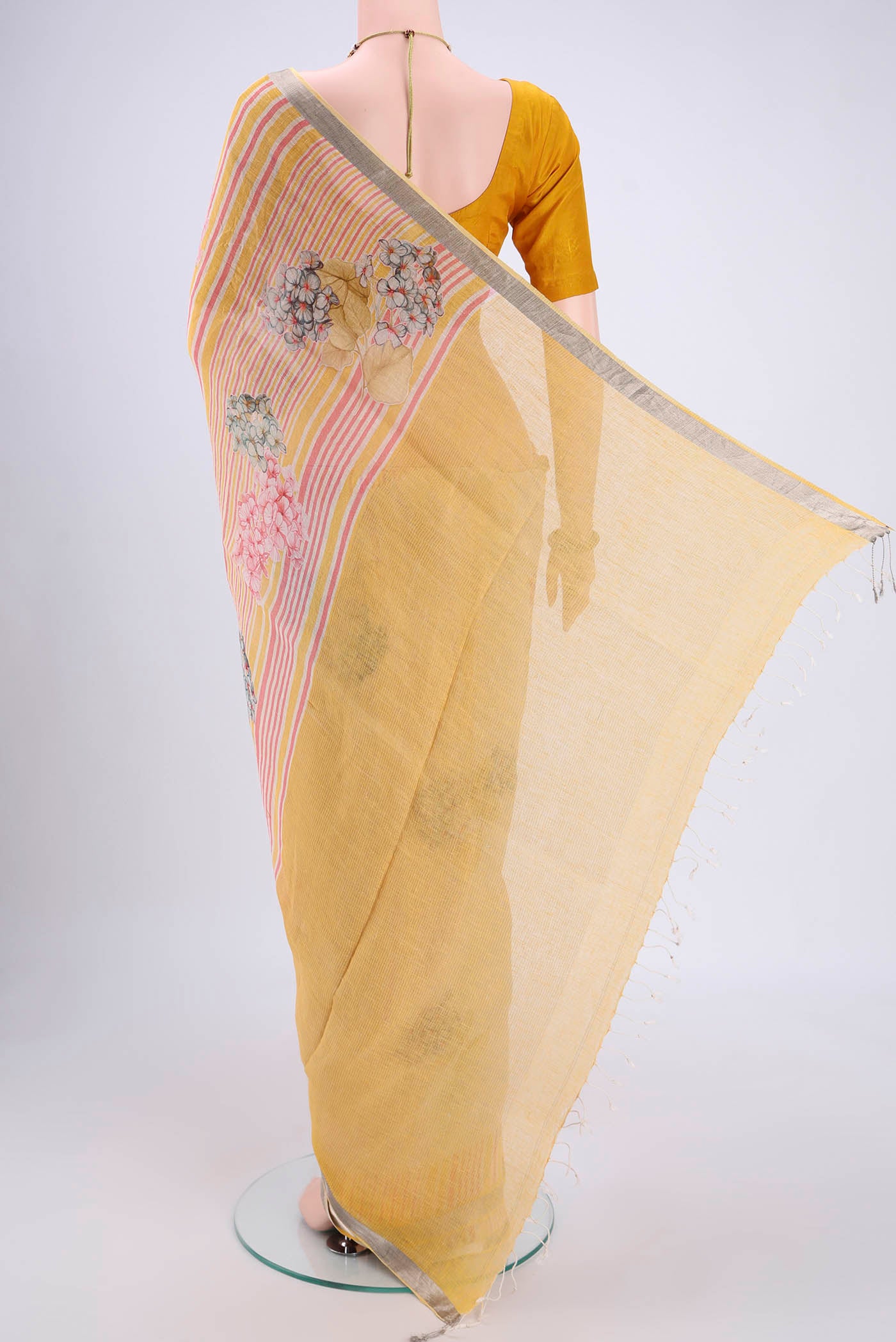 Flat view of Beige Linen Saree with Floral Print on the body and Zari Border. 