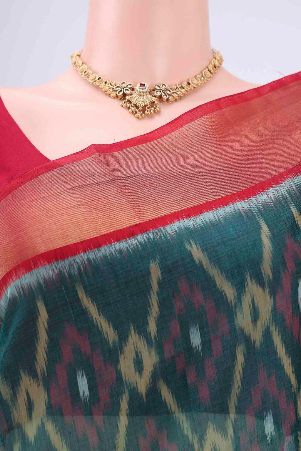 Border image of Green Silk Cotton Saree with Ikat design on the body and Zari Border. 
