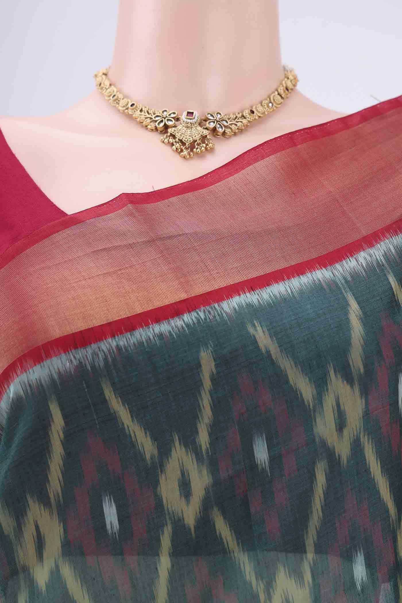 Border image of Green Silk Cotton Saree with Ikat design on the body and Zari Border. 