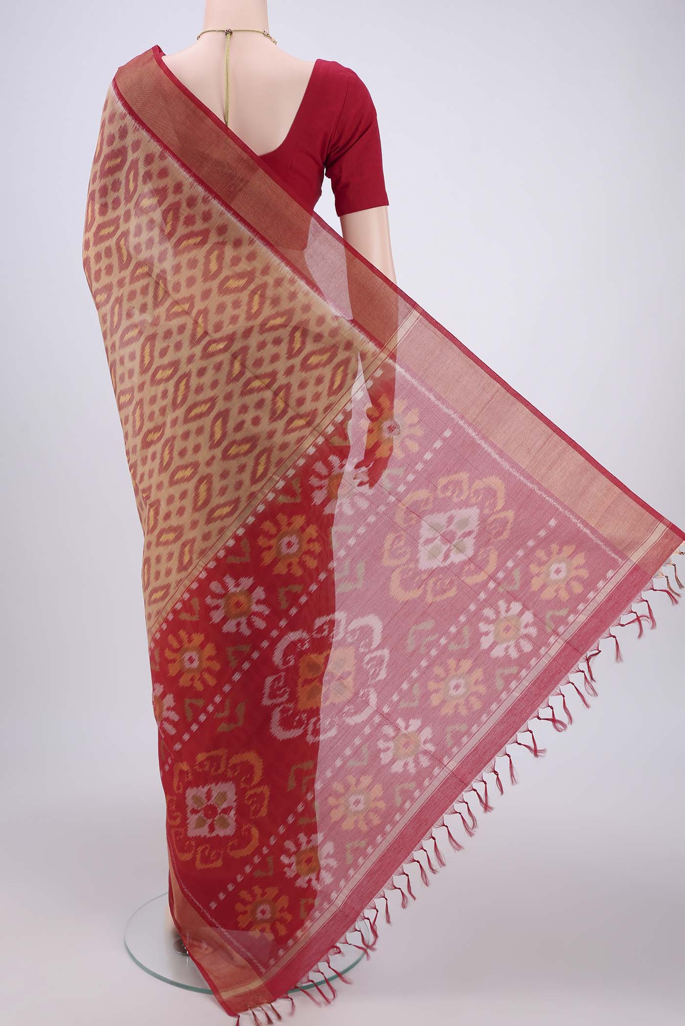 Flat view of Dark Beige Silk Cotton Saree with Ikat design on the body and Zari Border. 