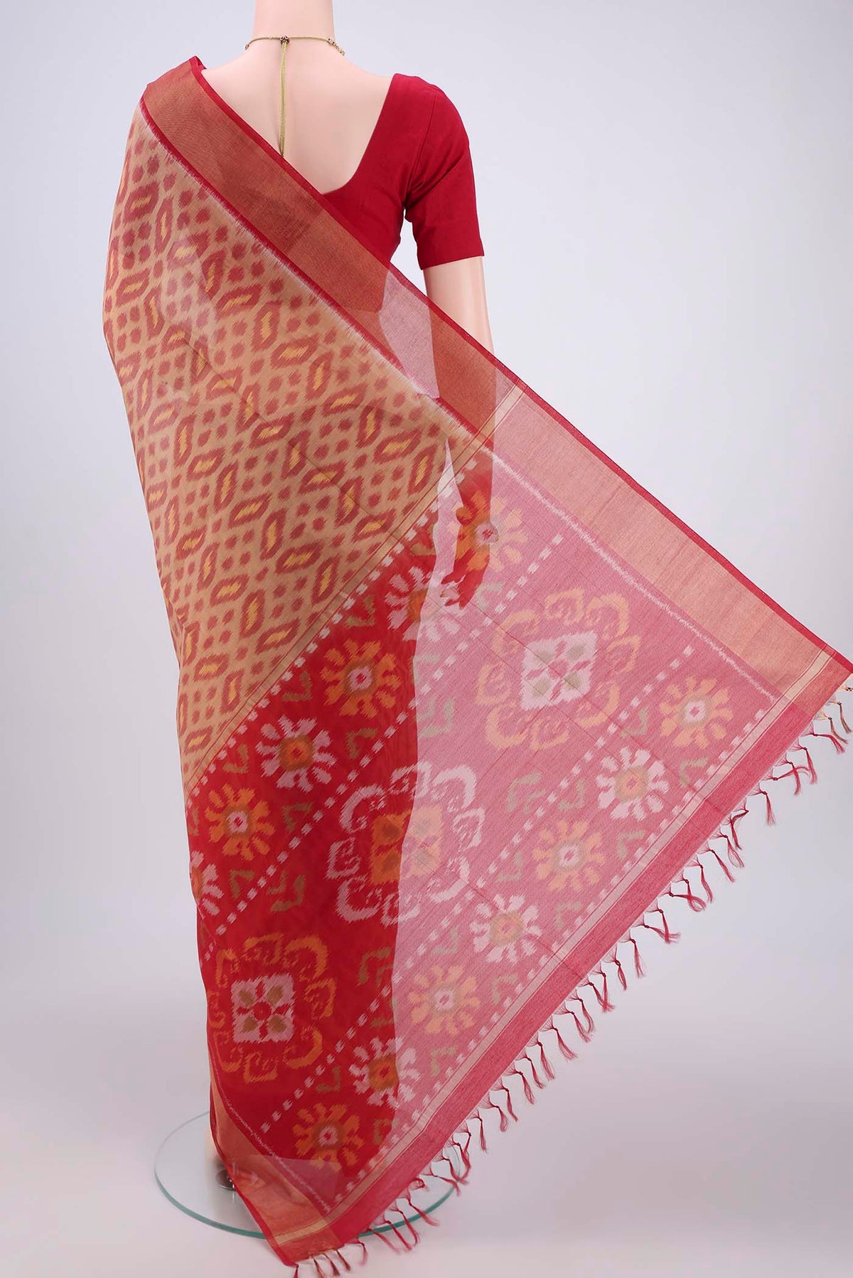 Flat view of Dark Beige Silk Cotton Saree with Ikat design on the body and Zari Border. 