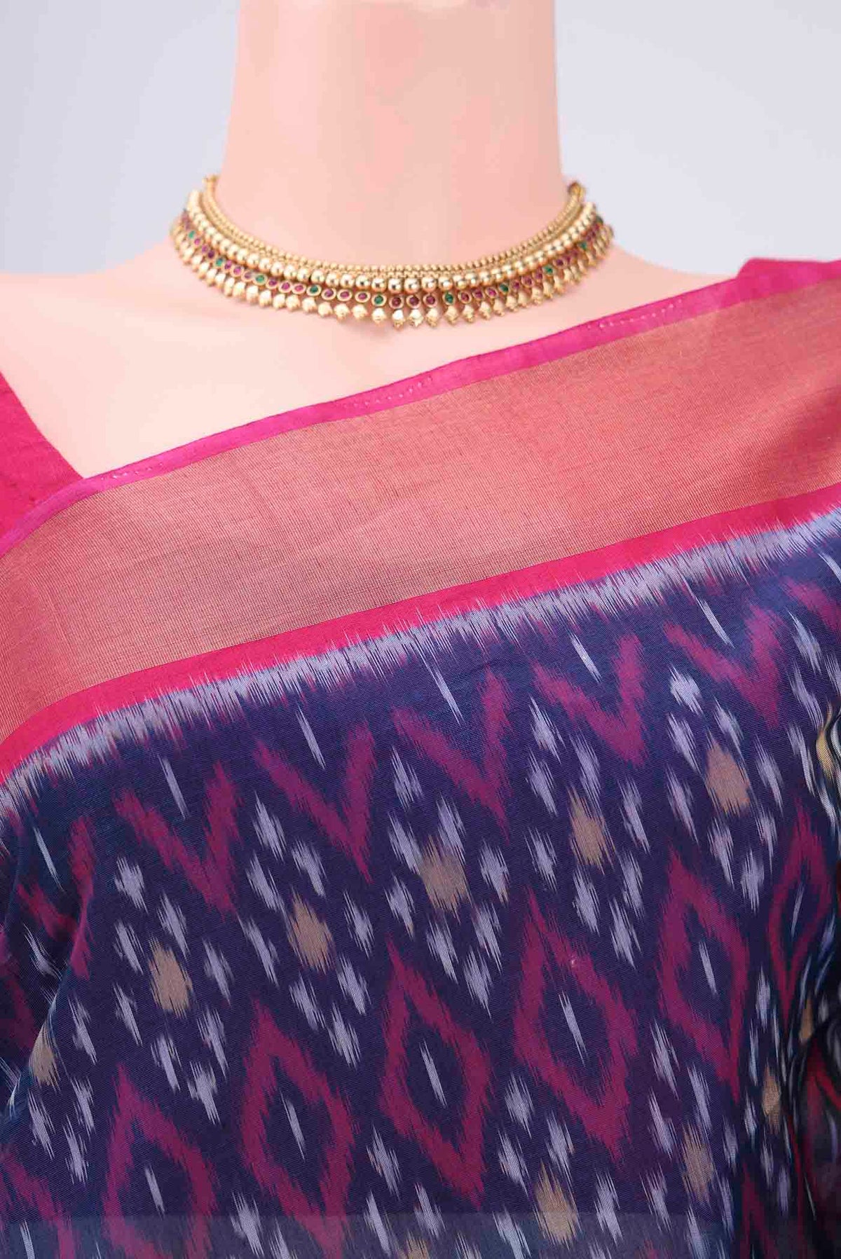 Border image of Navy Blue Silk Cotton Saree with Ikat design on the body and Zari Border. 