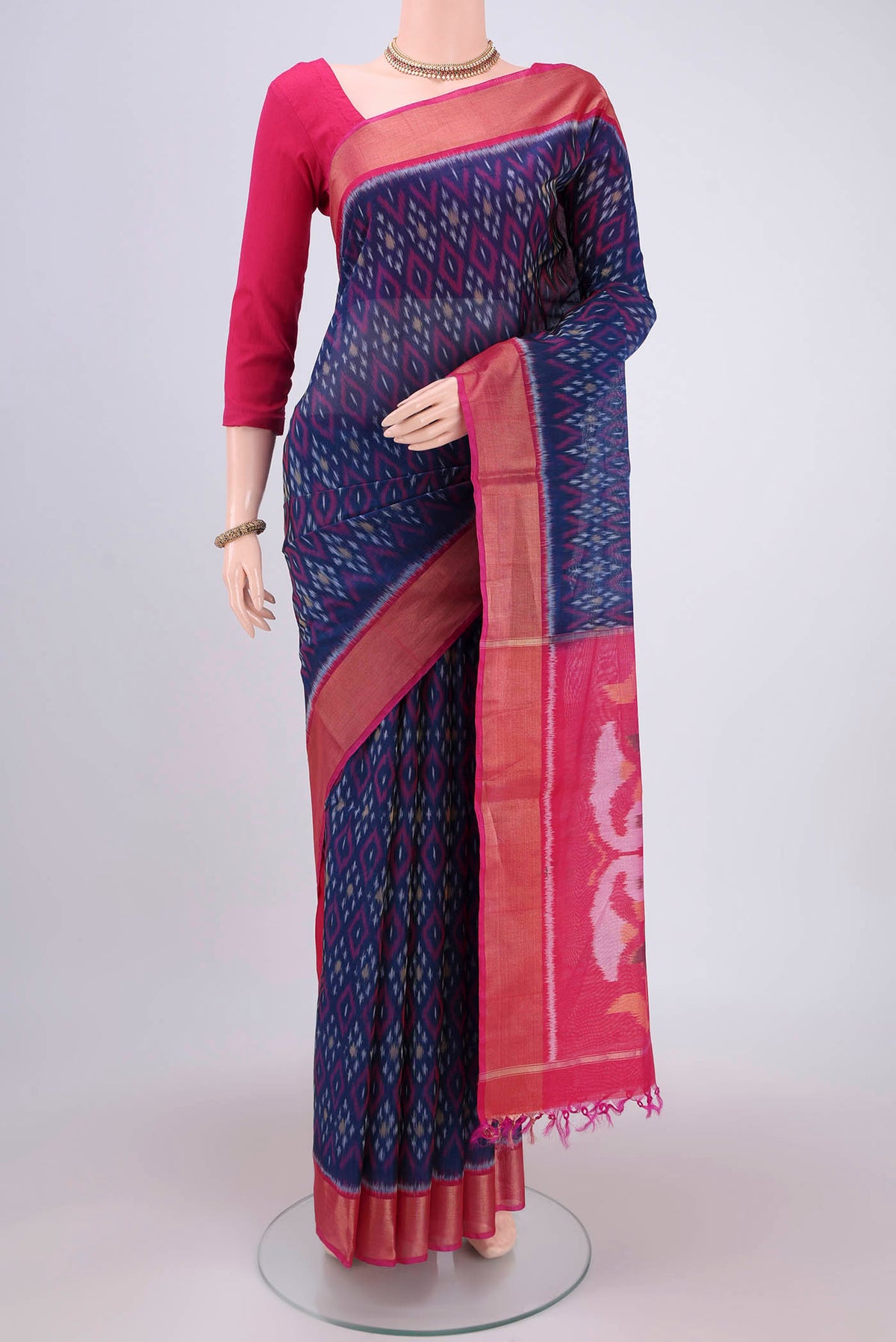 Navy Blue Silk Cotton Saree with Ikat design on the body and Zari Border.  displayed on a mannequin