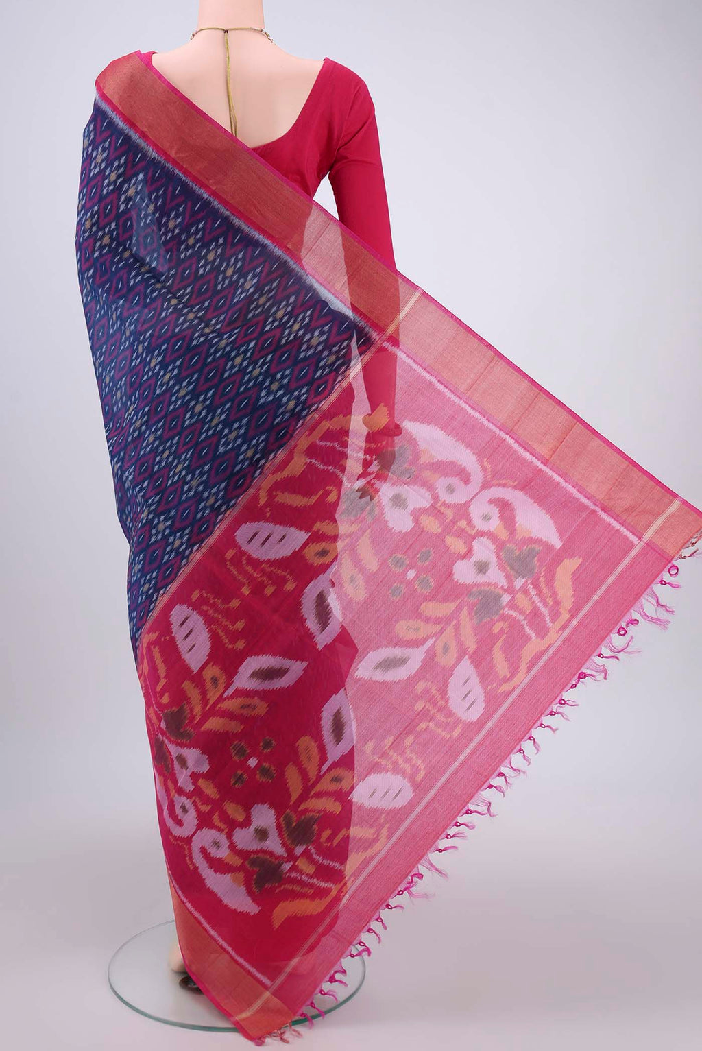 Flat view of Navy Blue Silk Cotton Saree with Ikat design on the body and Zari Border. 