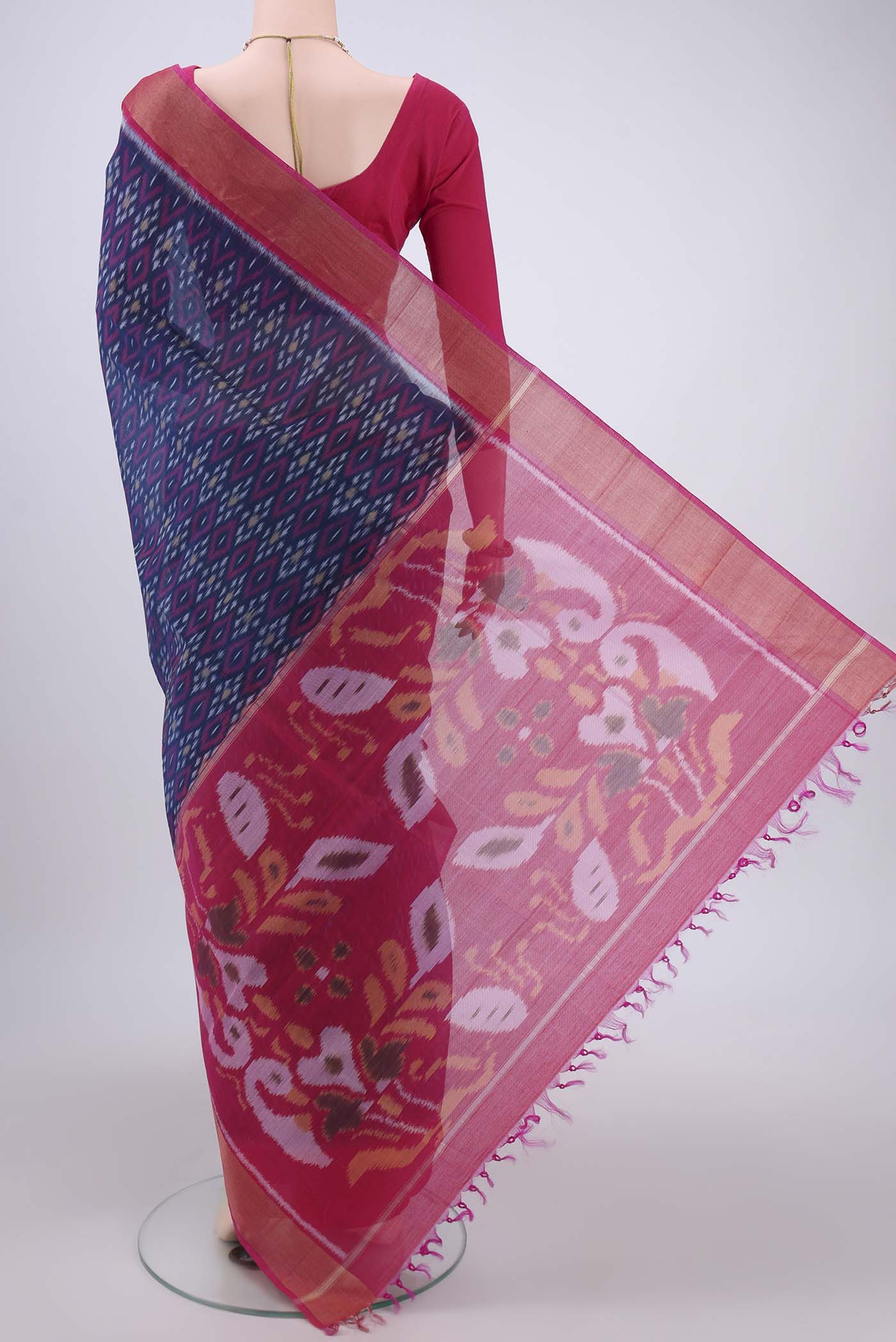 Flat view of Navy Blue Silk Cotton Saree with Ikat design on the body and Zari Border. 