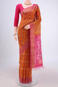 Mustard Silk Cotton Saree with Ikat design on the body and Zari Border.  displayed on a mannequin