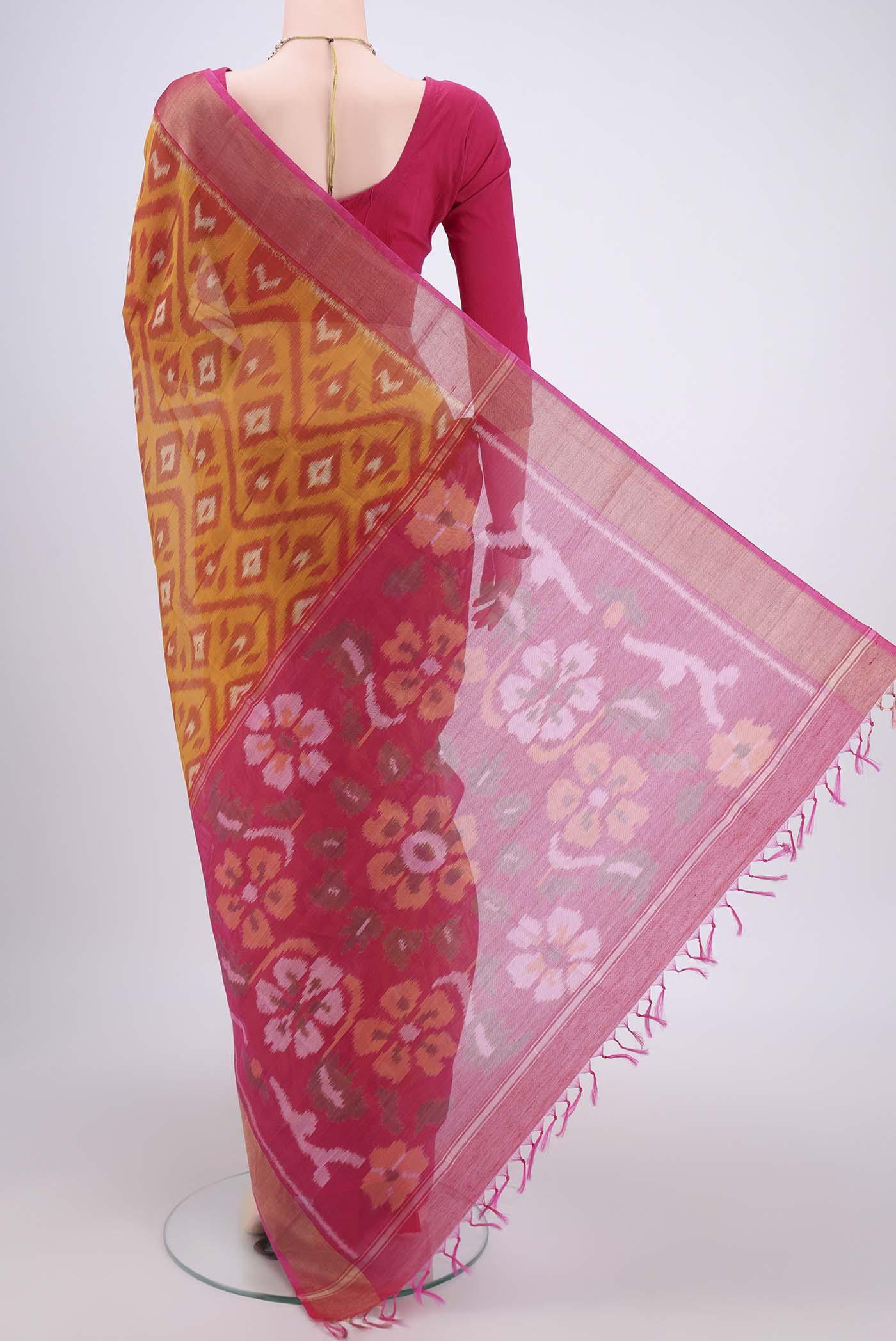 Flat view of Mustard Silk Cotton Saree with Ikat design on the body and Zari Border. 