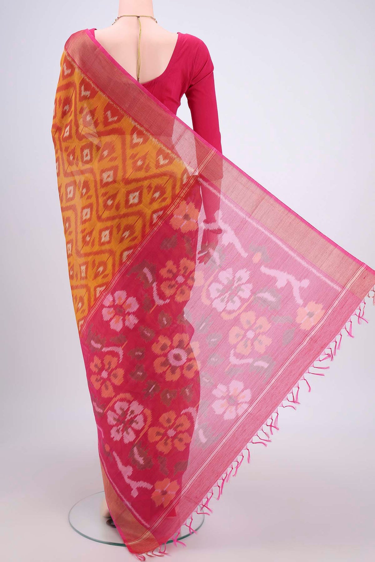 Flat view of Mustard Silk Cotton Saree with Ikat design on the body and Zari Border. 