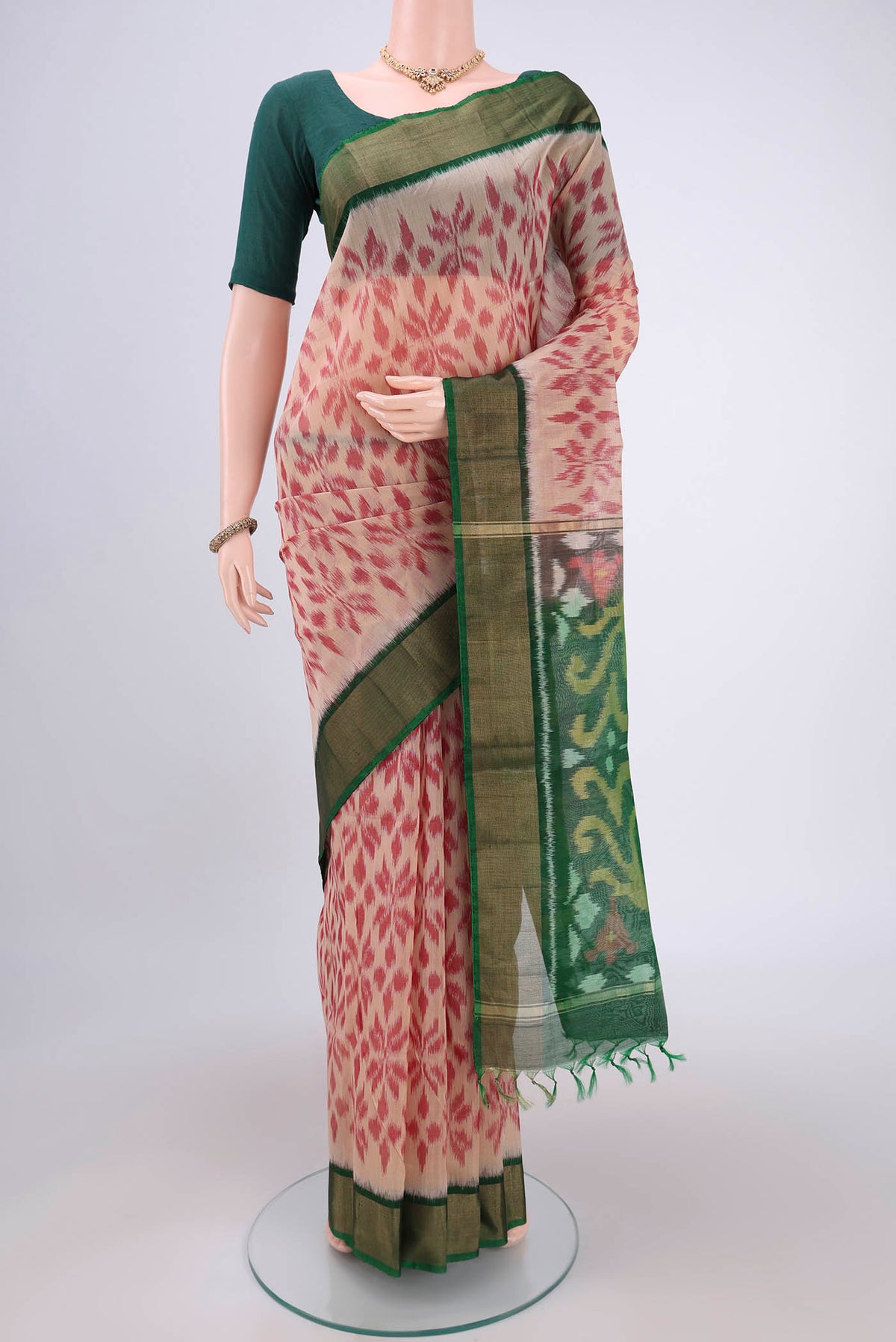 Beige Silk Cotton Saree with Ikat design on the body and Zari Border.  displayed on a mannequin