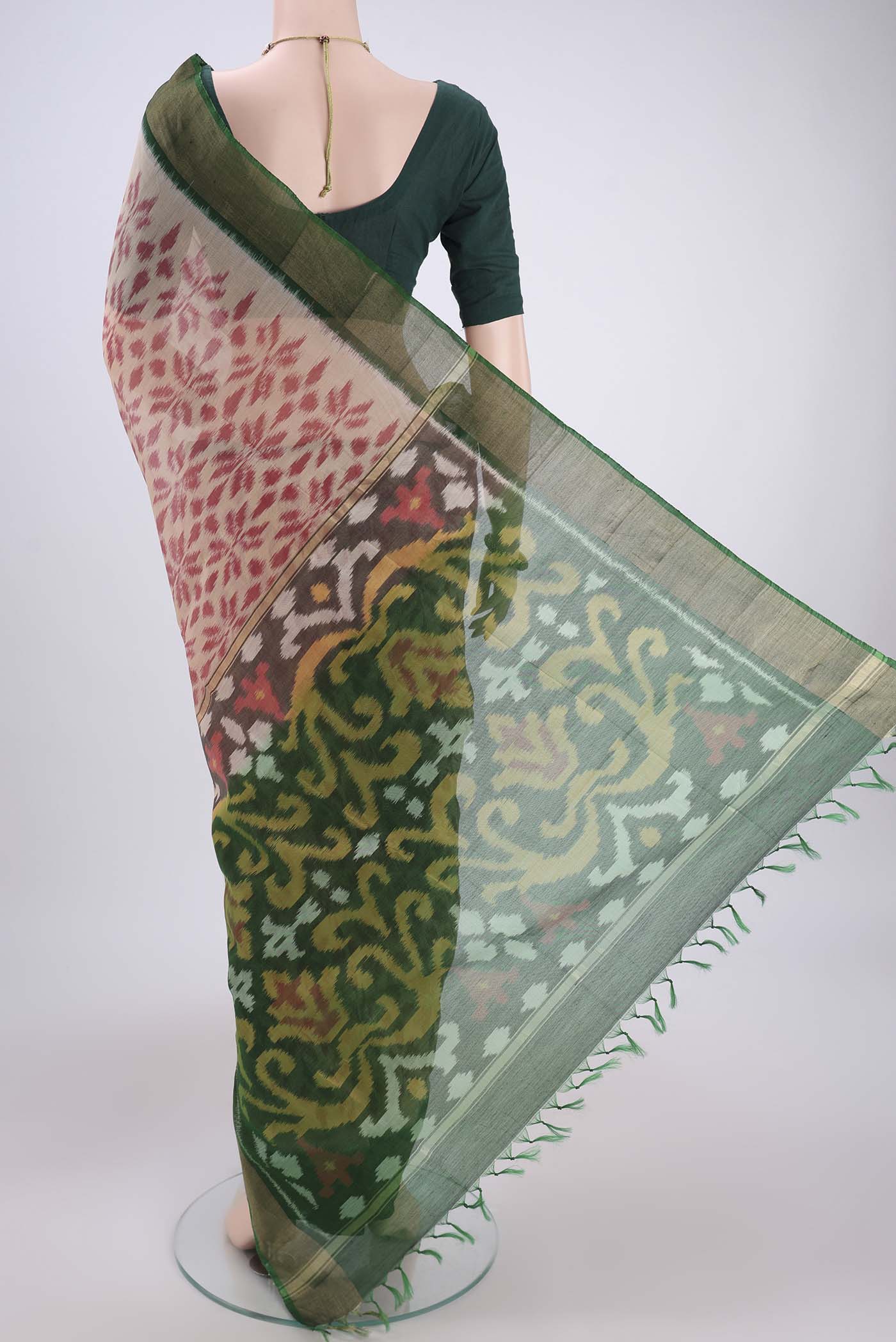 Flat view of Beige Silk Cotton Saree with Ikat design on the body and Zari Border. 