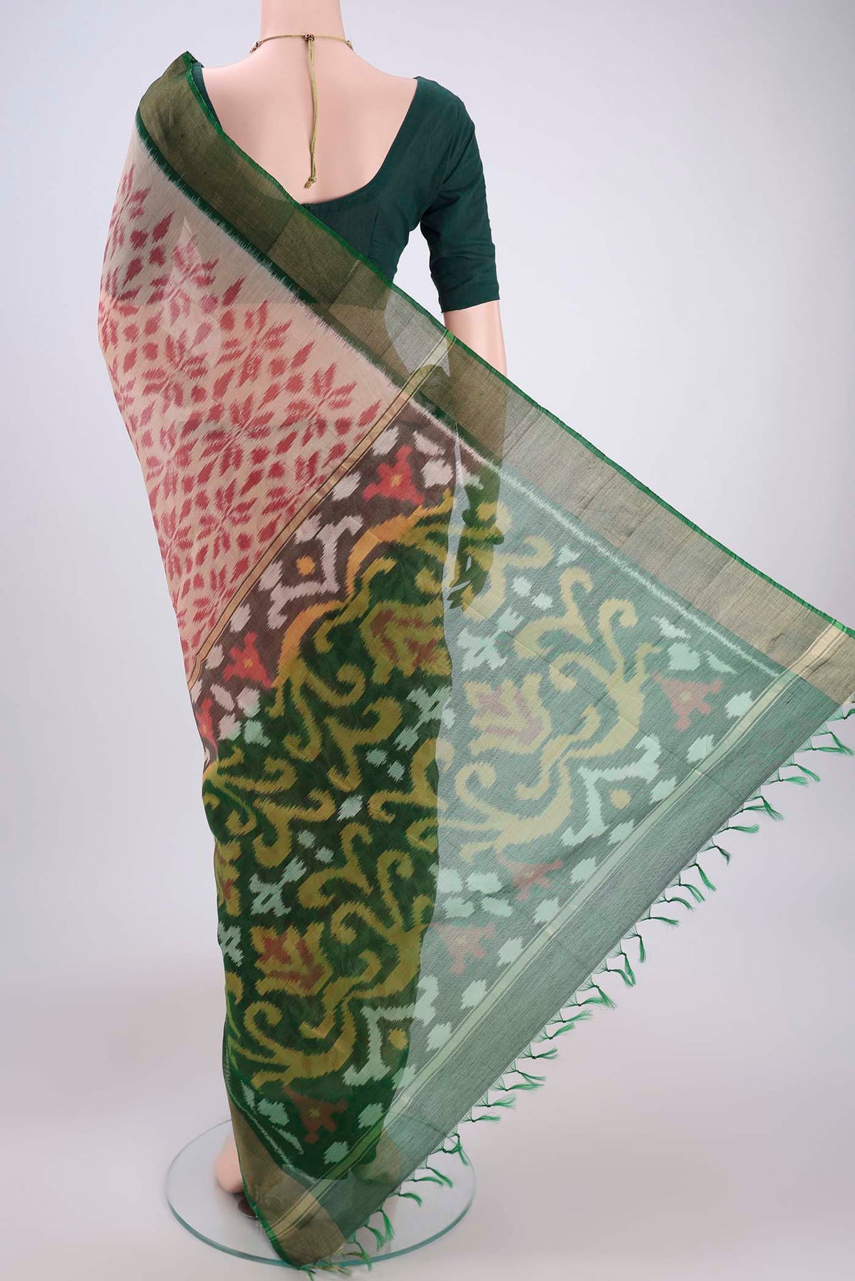 Flat view of Beige Silk Cotton Saree with Ikat design on the body and Zari Border. 