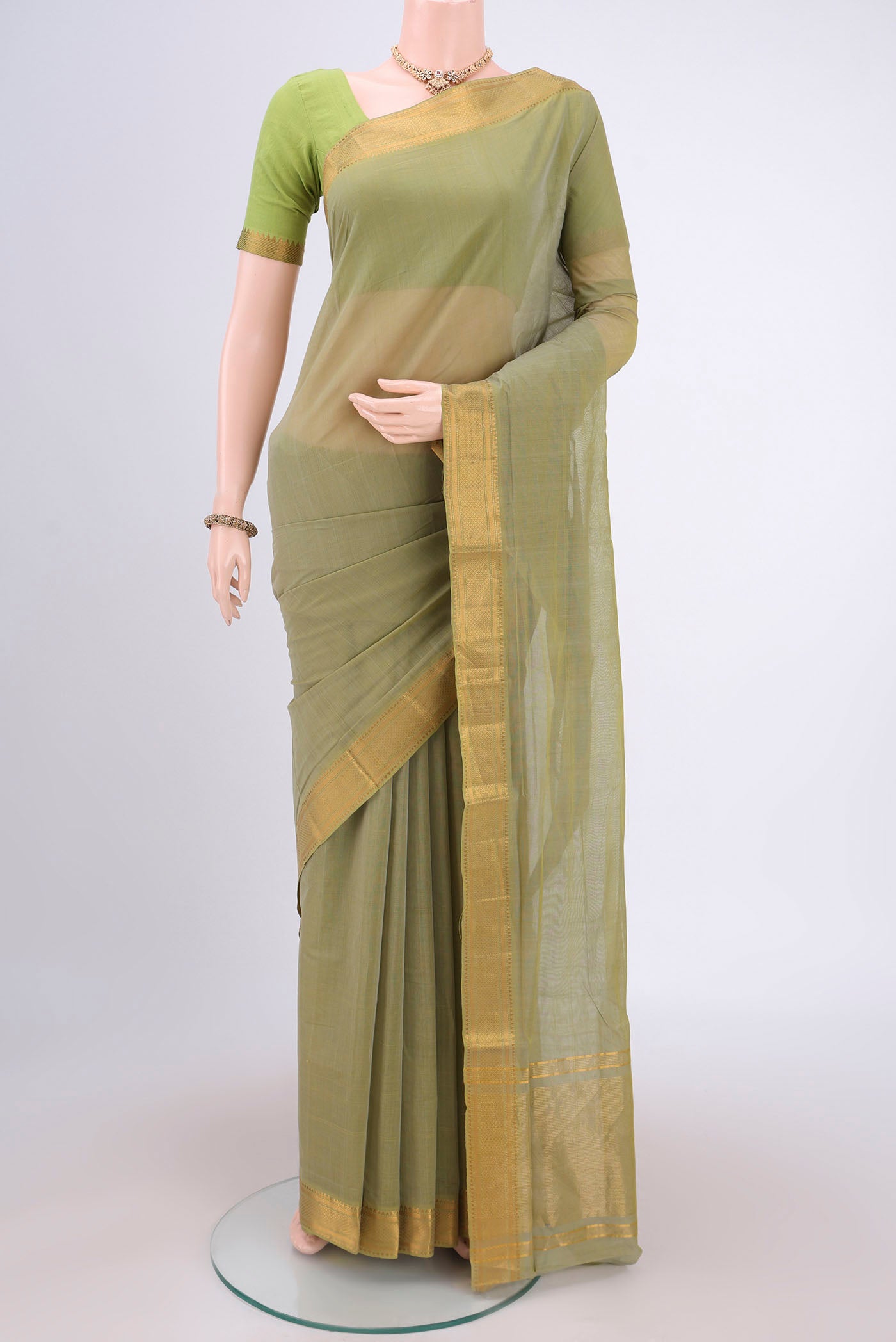 Light Green Mangalagiri Cotton Saree with Plain Body and Zari Border.  displayed on a mannequin