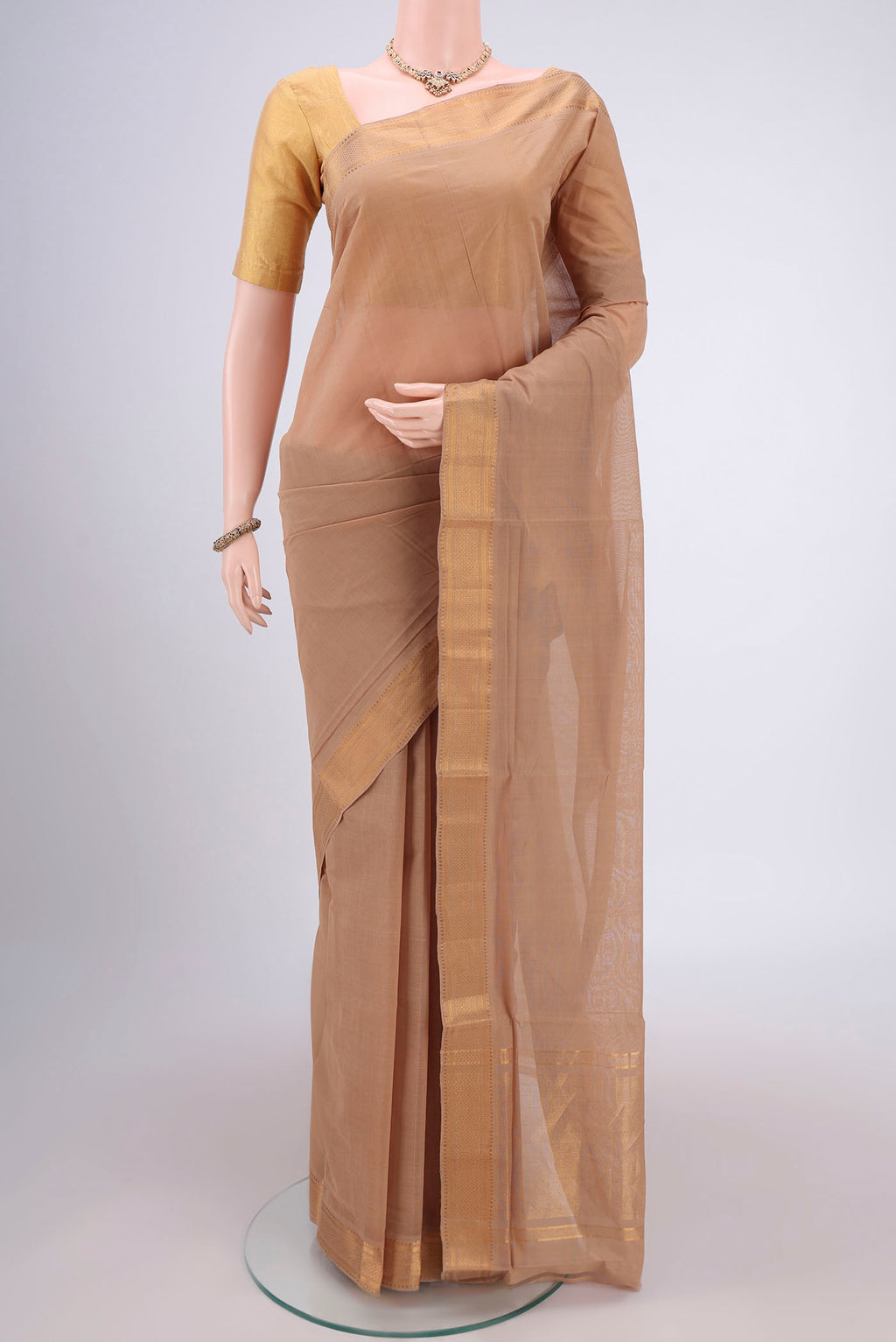 Beige Mangalagiri Cotton Saree with Plain Body and Zari Border.  displayed on a mannequin