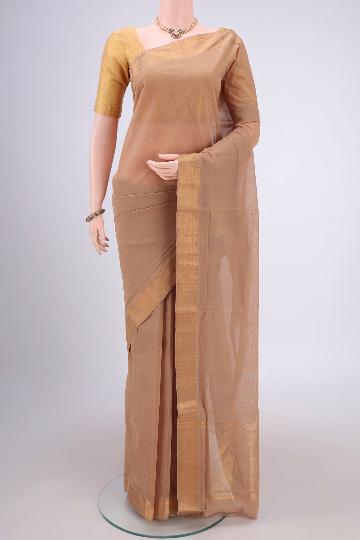 Beige Mangalagiri Cotton Saree with Plain Body and Zari Border.  displayed on a mannequin