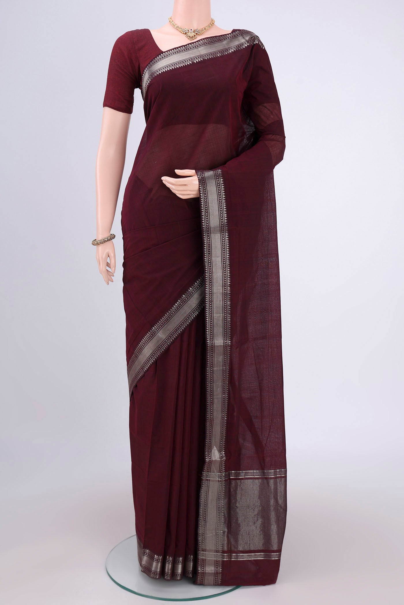 Maroon Mangalagiri Cotton Saree with Plain Body and Zari Border.  displayed on a mannequin