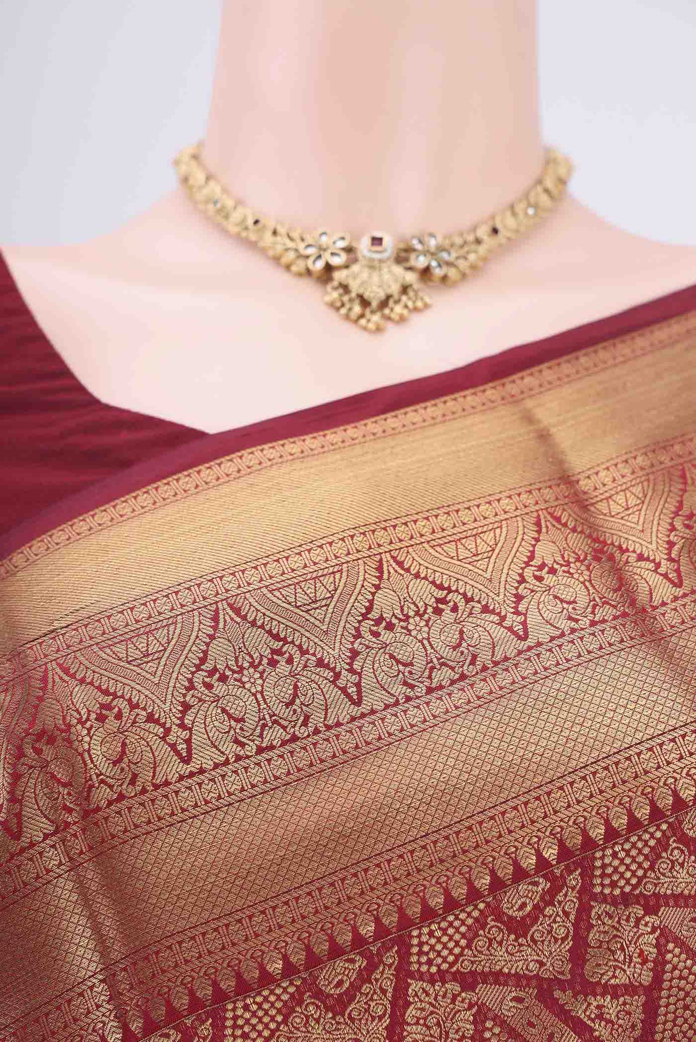 Border image of Maroon Soft Silk Saree with Zari Butta on the body and Zari Border. 