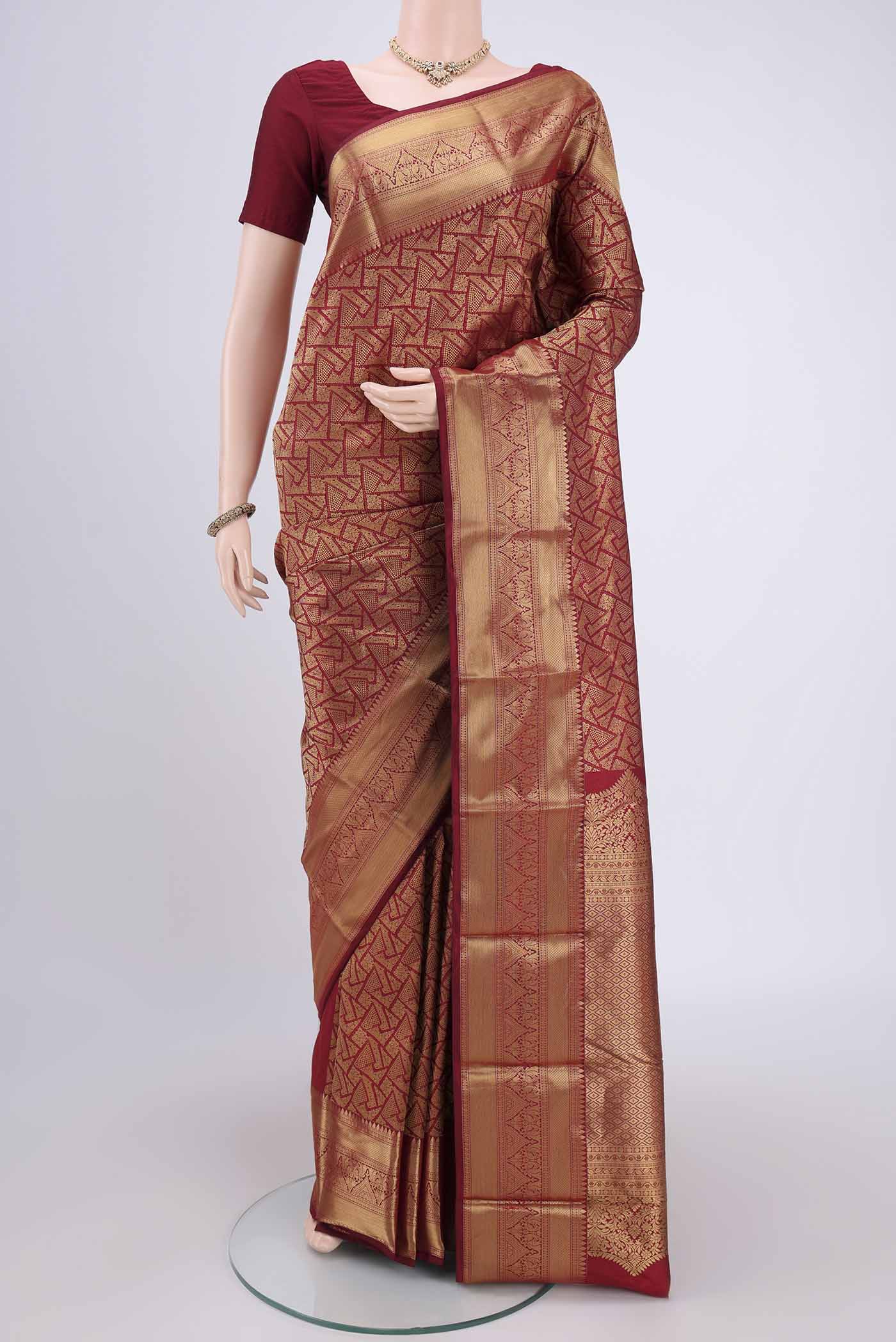 Maroon Soft Silk Saree with Zari Butta on the body and Zari Border.  displayed on a mannequin