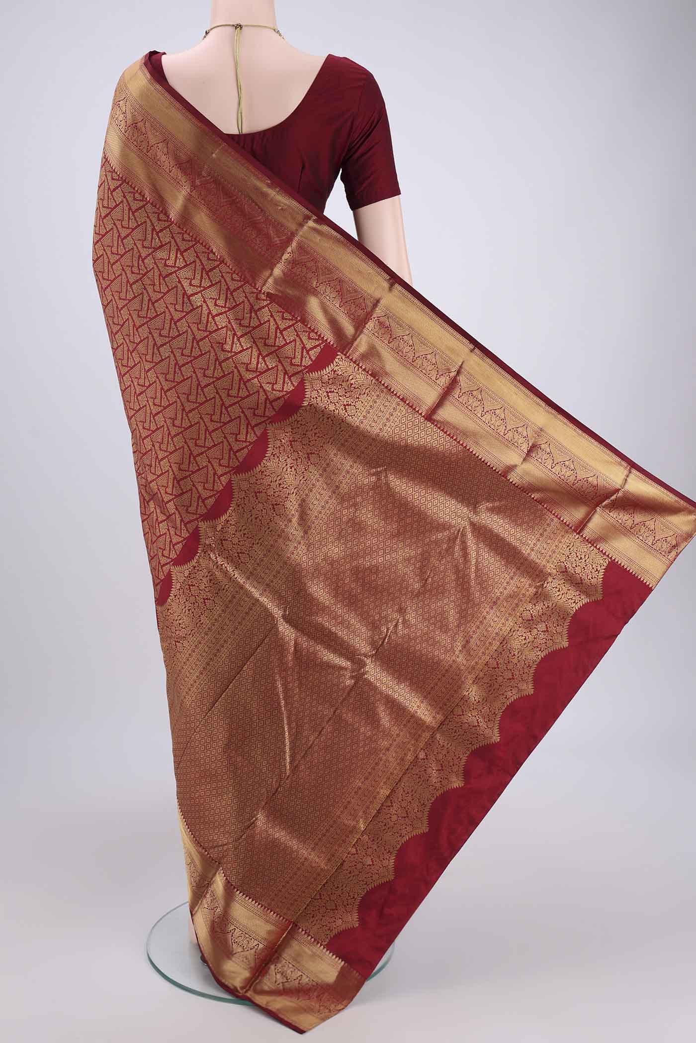 Flat view of Maroon Soft Silk Saree with Zari Butta on the body and Zari Border. 