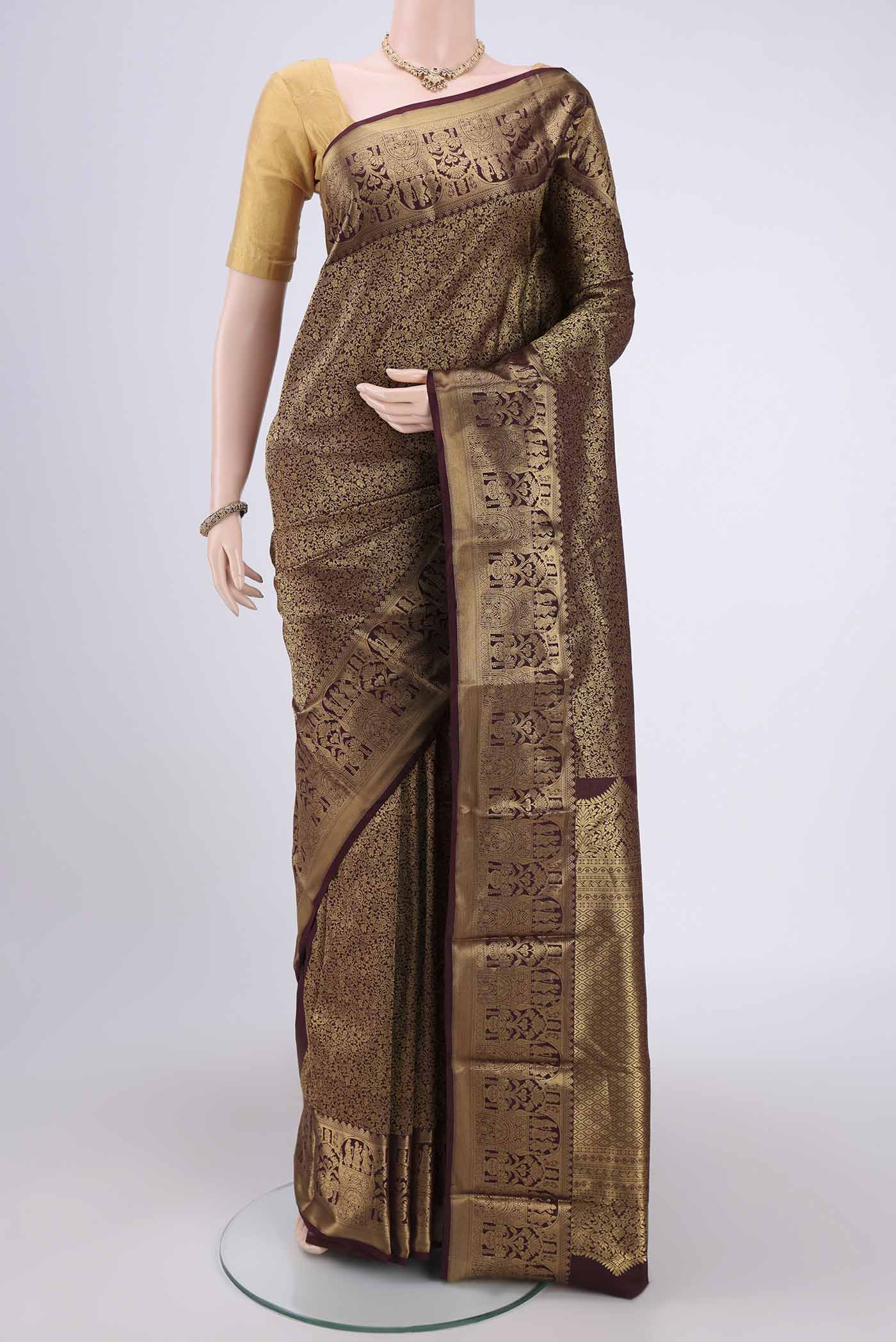 Brown Soft Silk Saree with Zari Butta on the body and Zari Border.  displayed on a mannequin