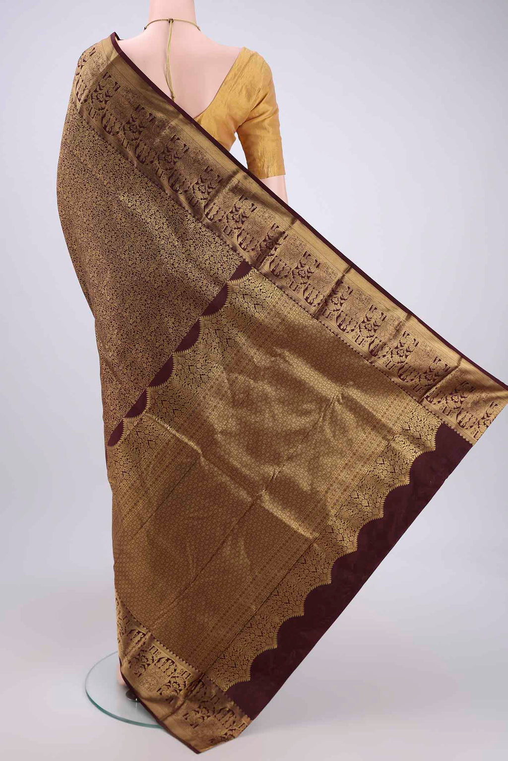Flat view of Brown Soft Silk Saree with Zari Butta on the body and Zari Border. 