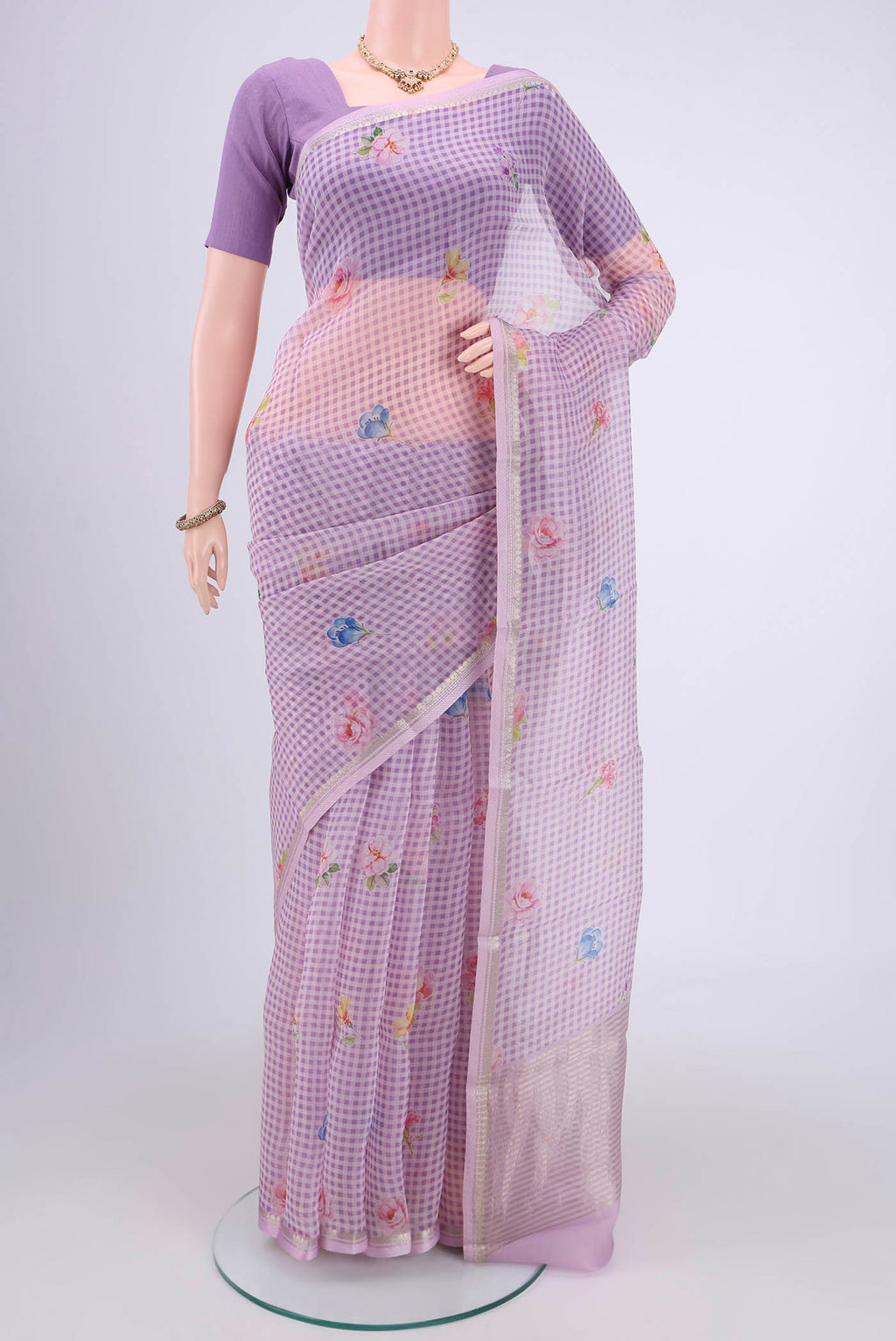Lavender Organza Silk Saree with Printed design on the body and Zari Border.  displayed on a mannequin
