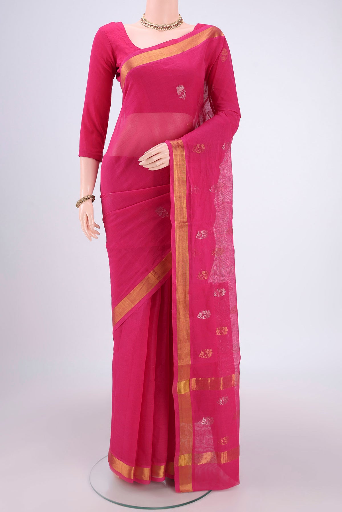 Rani Pink Venkatagiri Cotton Saree with Zari Butta on the body and Zari Border.  displayed on a mannequin