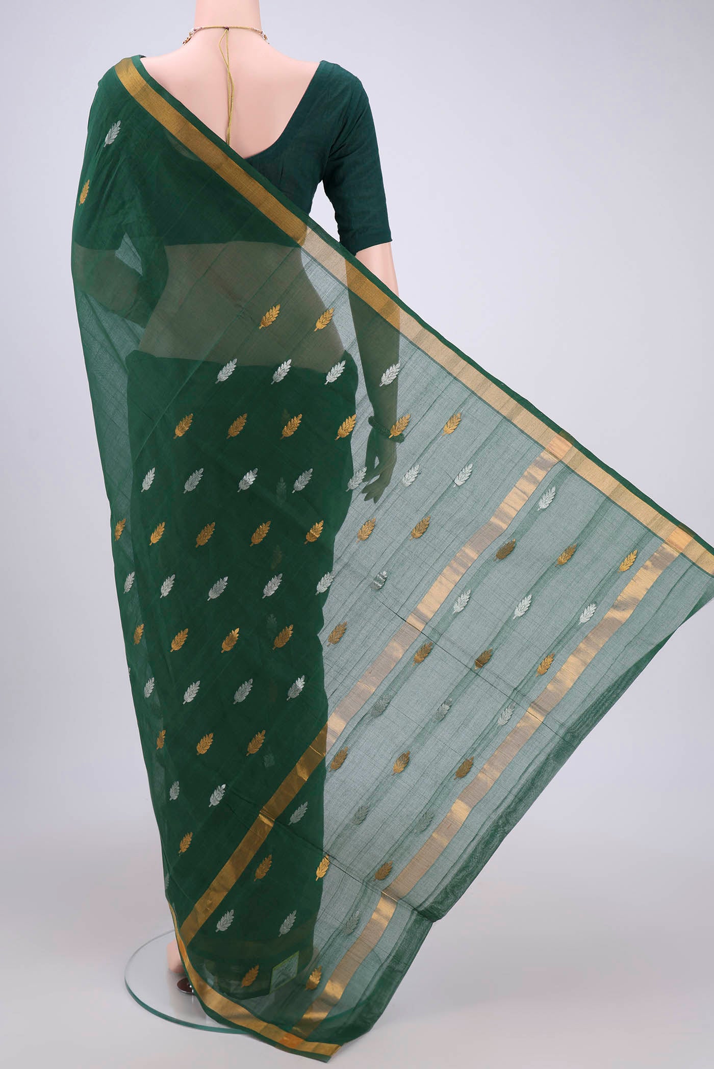 Flat view of Green Cotton Saree with Zari Butta on the body and Zari Border. 