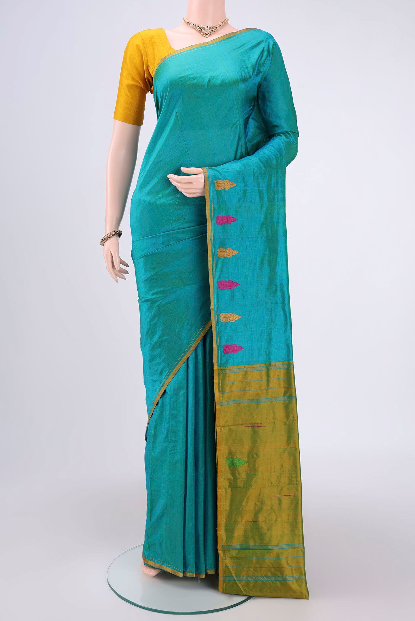 Sea Green Dual Tone Kanchipuram Silk Saree with Plain Body and Thread Border.  displayed on a mannequin