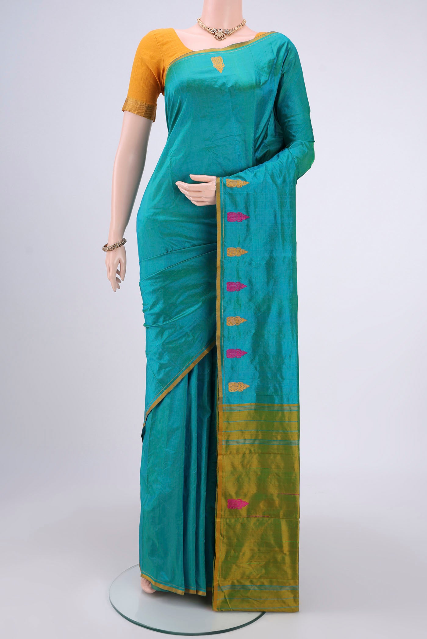 Sea Green Dual Tone Kanchipuram Silk Saree with Plain Body and Zari And Thread Border.  displayed on a mannequin