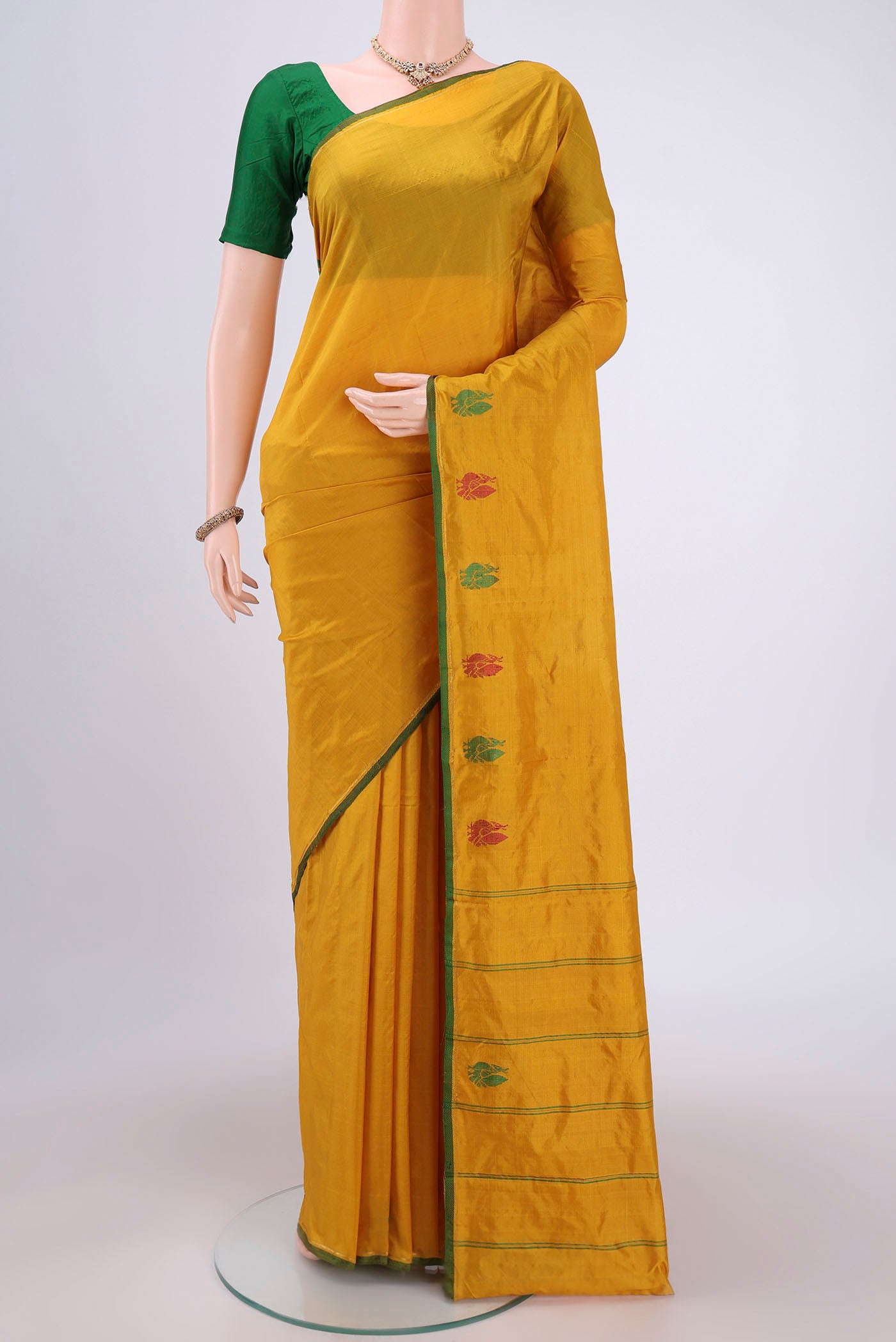 Mustard Dual Tone Kanchipuram Silk Saree with Plain Body and Zari And Thread Border.  displayed on a mannequin