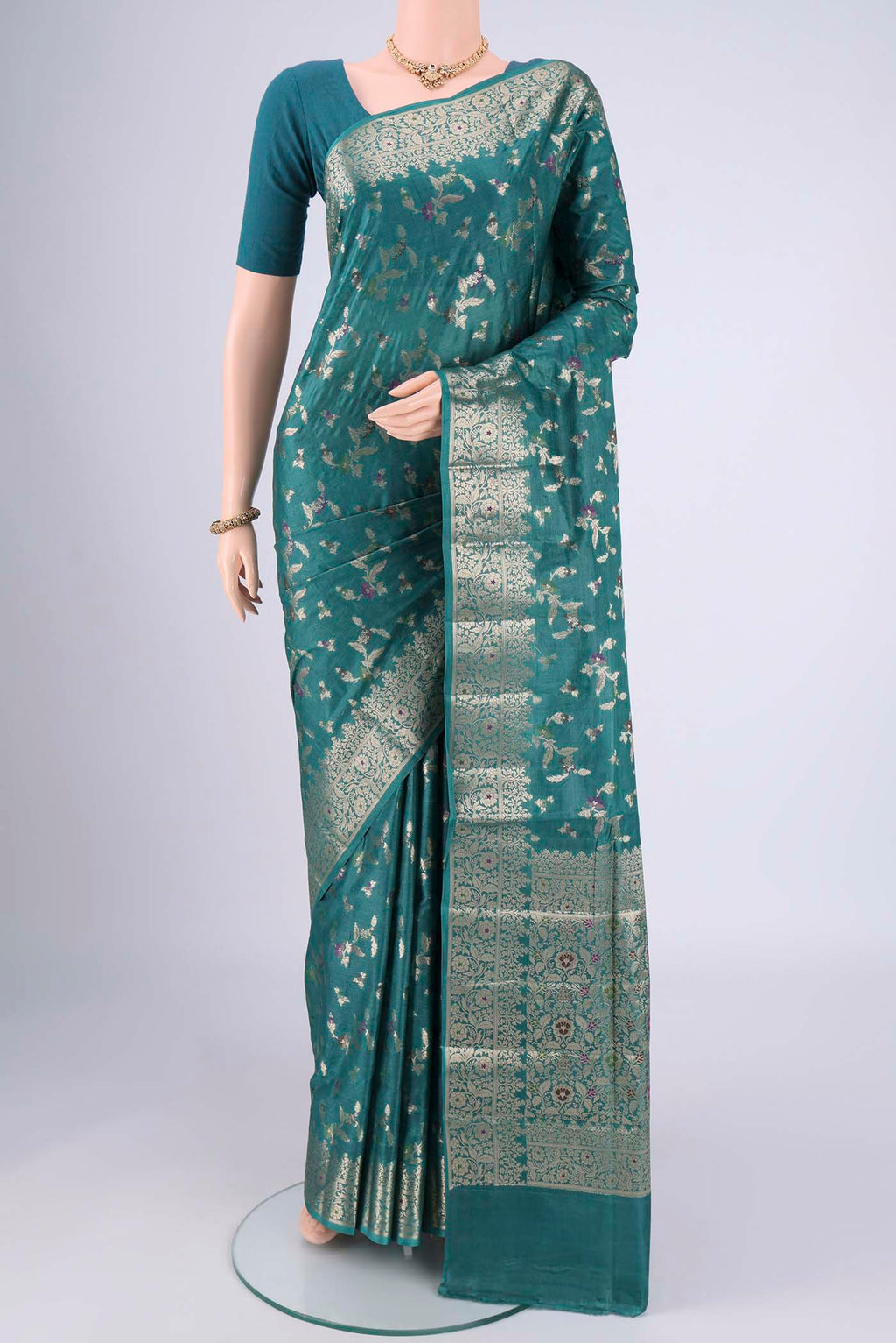 Sea Green Banarasi Tussar Silk Saree with Zari And Thread Butta on the body and Zari And Thread Border.  displayed on a mannequin