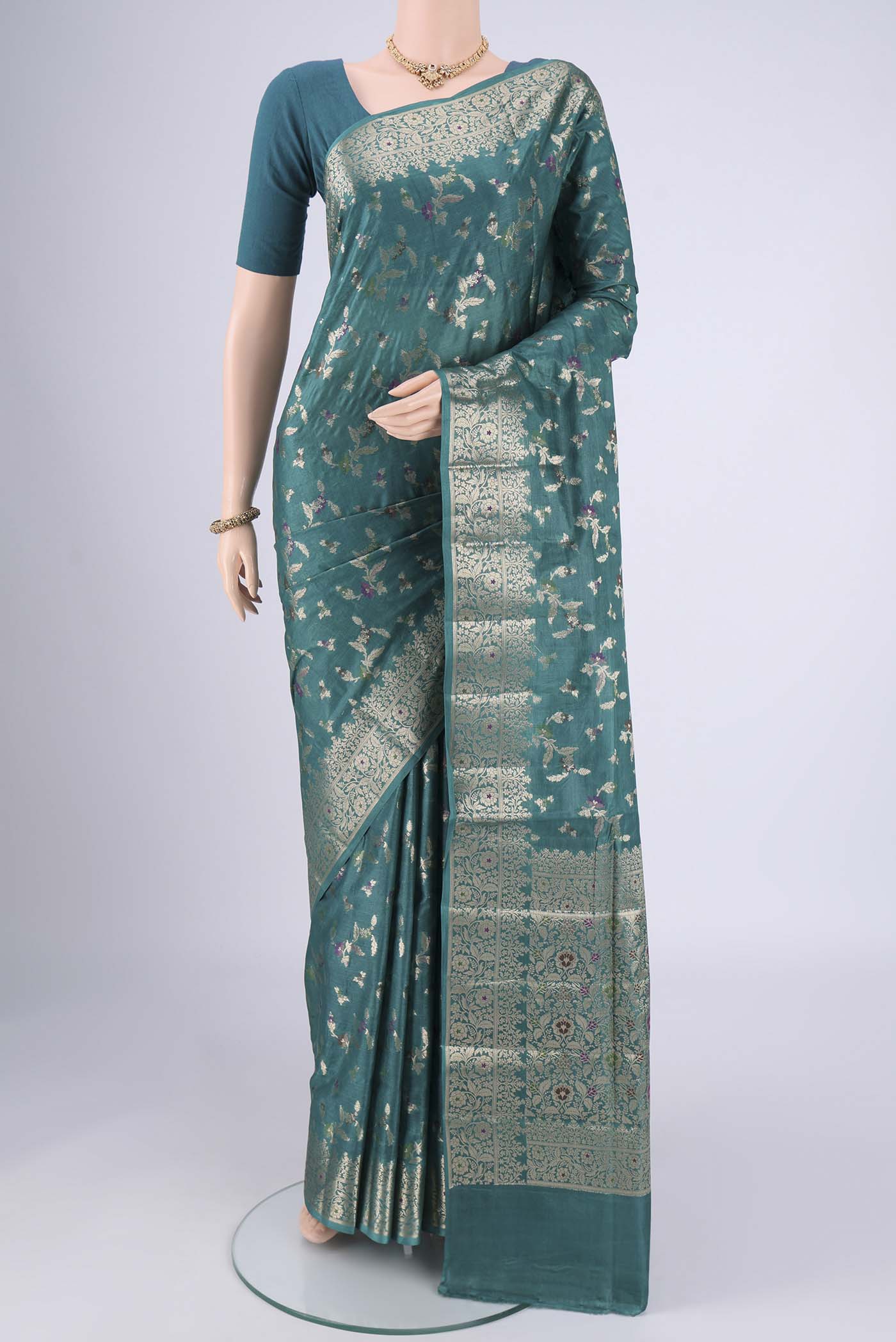 Sea Green Banarasi Tussar Silk Saree with Zari And Thread Butta on the body and Zari And Thread Border.  displayed on a mannequin