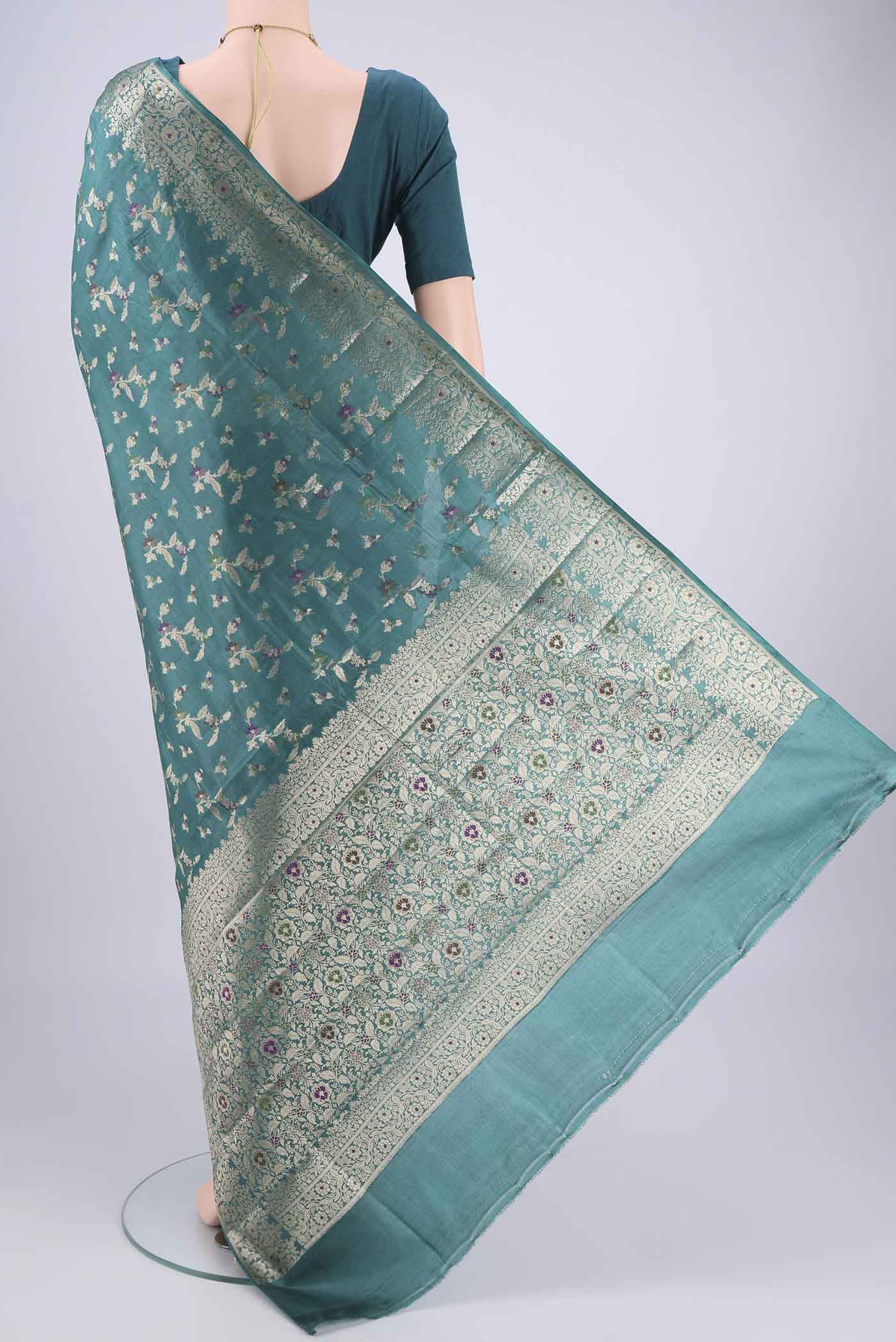 Flat view of Sea Green Banarasi Tussar Silk Saree with Zari And Thread Butta on the body and Zari And Thread Border. 